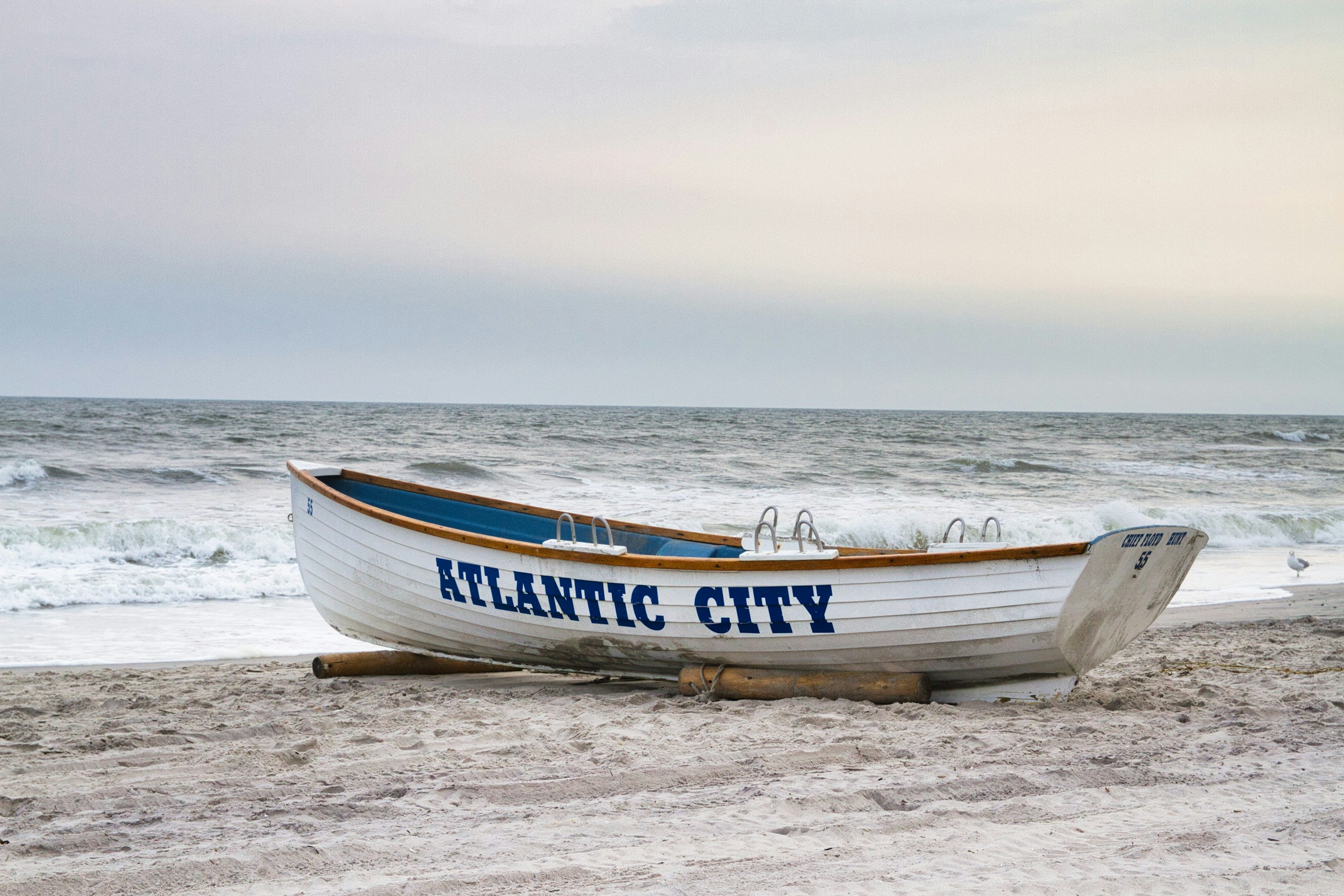 White Atlantic City lifeboat on a sandy beach HD Wallpaper