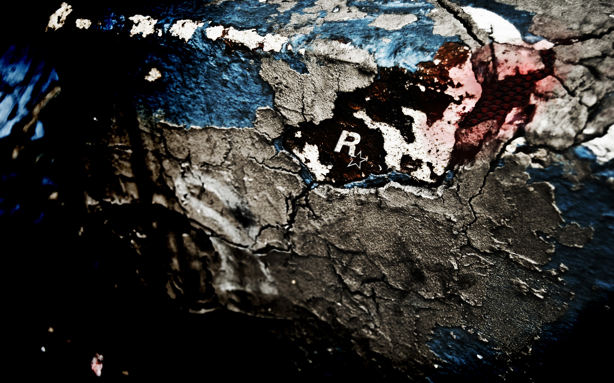 Gritty Rockstar Games Logo on Cracked Textured Surface HD Wallpaper
