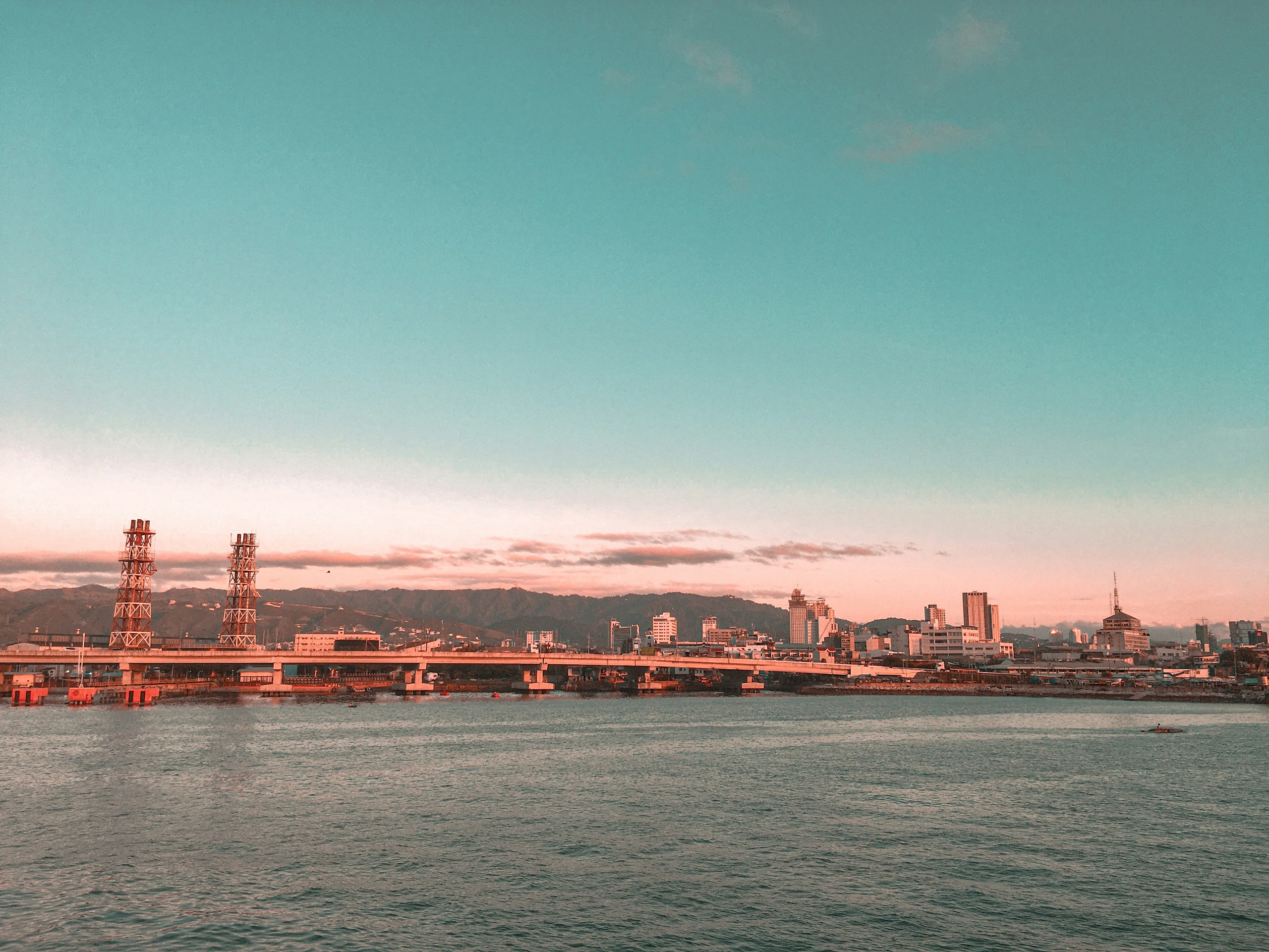 Coastal City Skyline with Bridge at Sunset HD Wallpaper