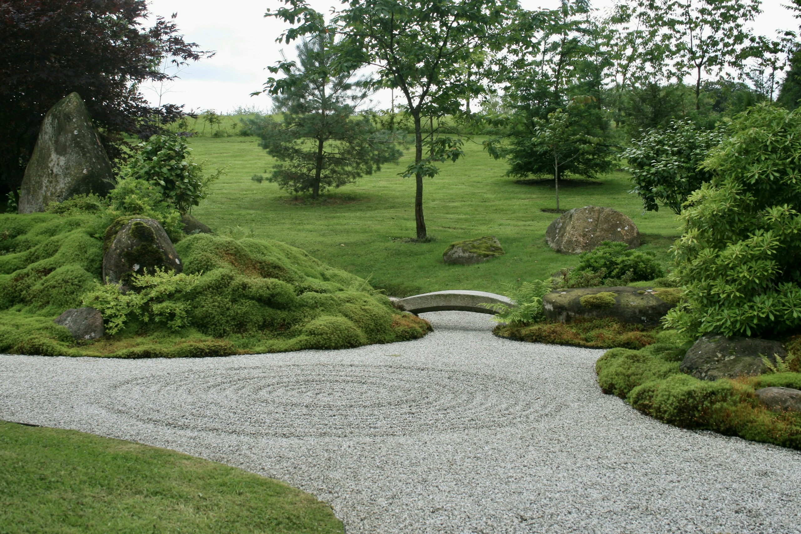 Japanese Zen Garden with Raked Gravel and Stone Bridge HD Wallpaper