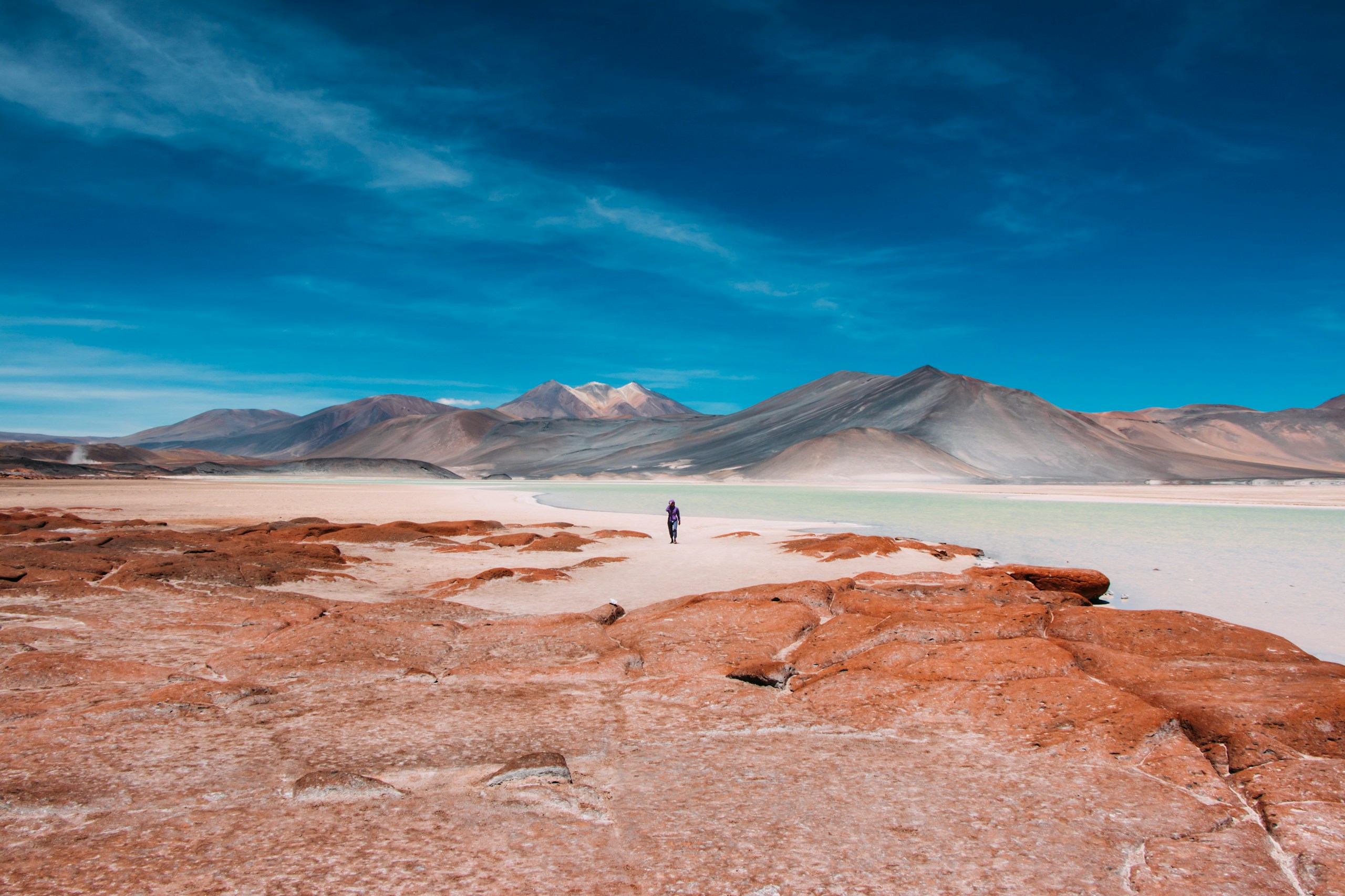 Lone person walking in Atacama Desert landscape HD Wallpaper