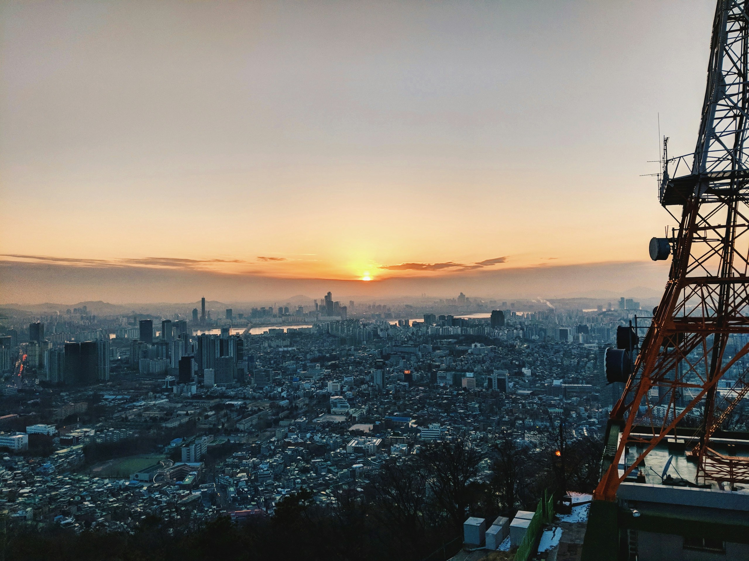 City skyline at sunset with transmission tower HD Wallpaper