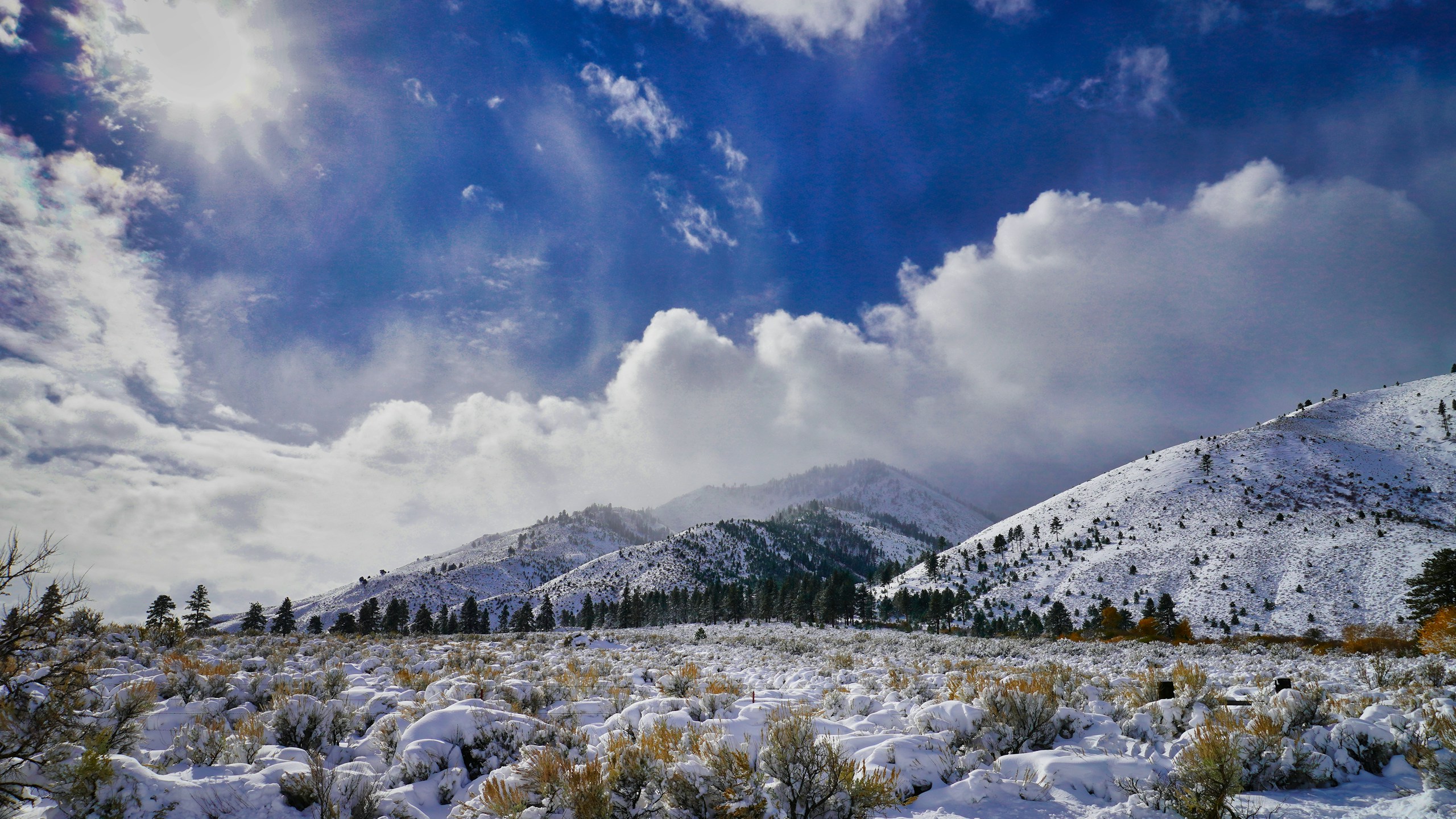 Snow Covered Mountains and Valley Under Blue Sky HD Wallpaper