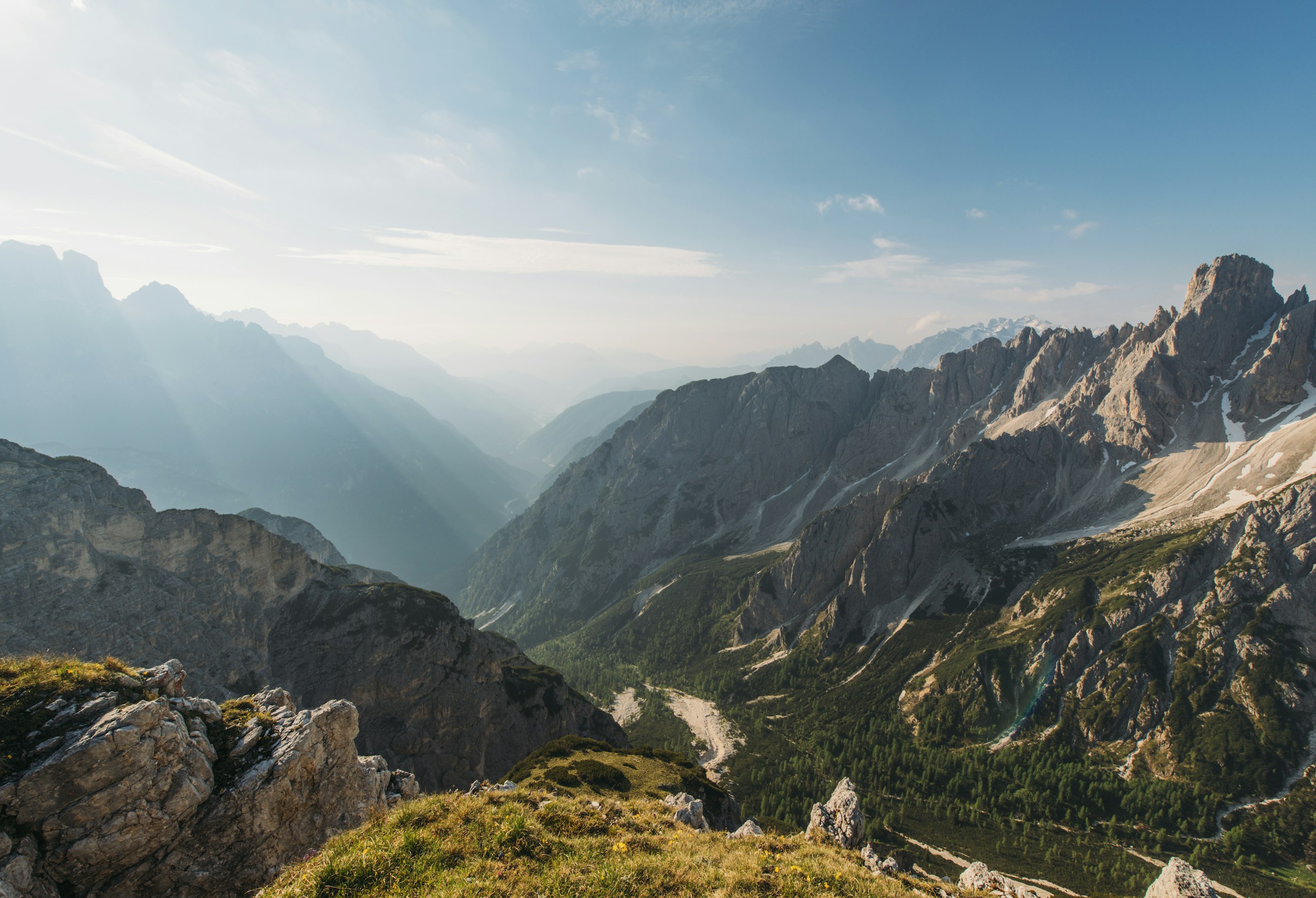 Rugged mountain peaks and deep valley landscape HD Wallpaper