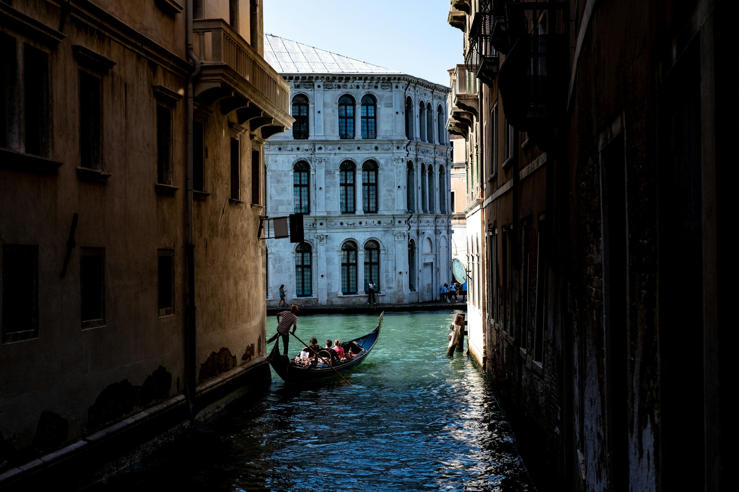Gondola navigating a narrow canal in Venice HD Wallpaper