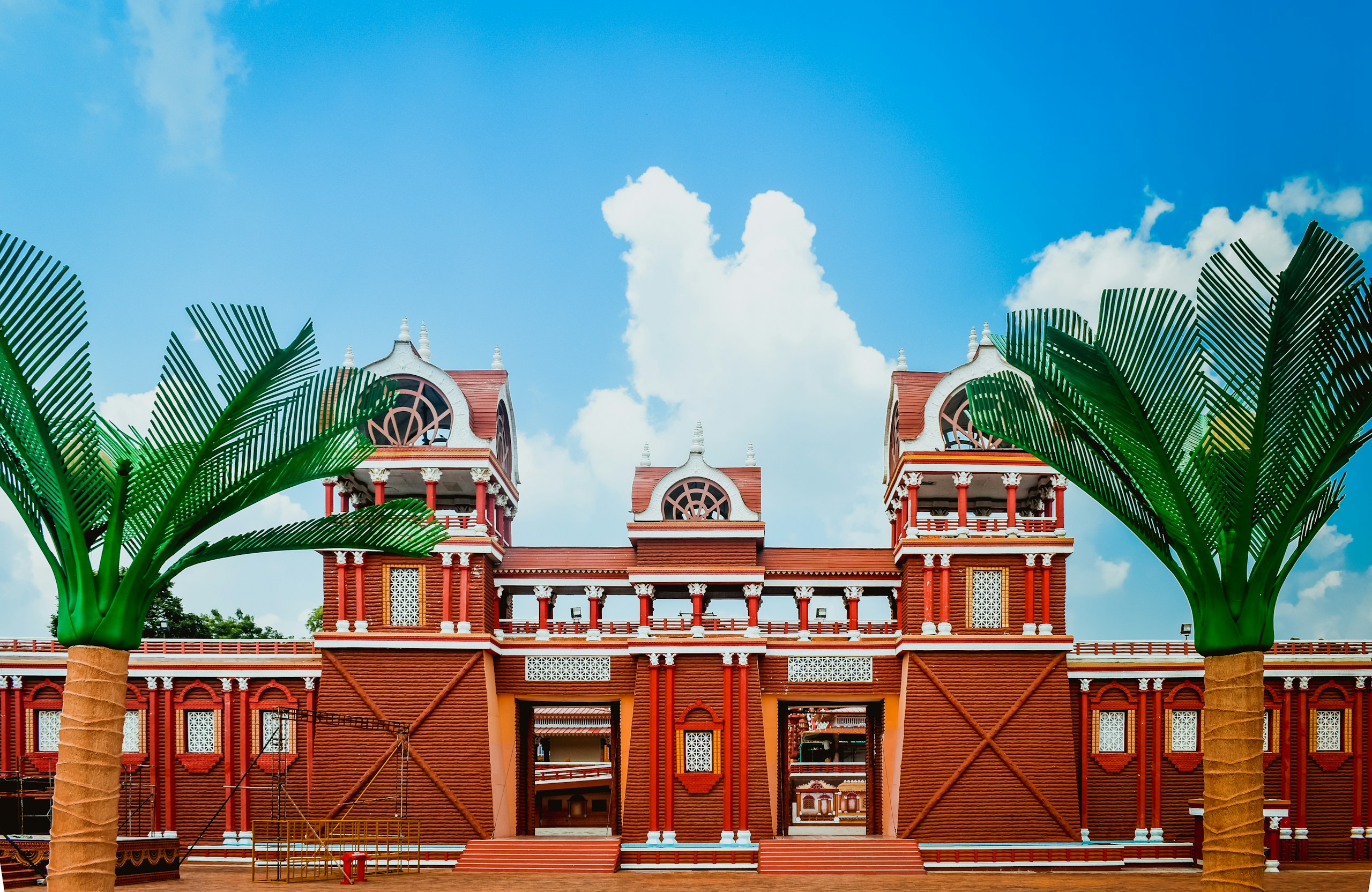 Red and Brown Architectural Gateway with Artificial Palm Trees HD Wallpaper