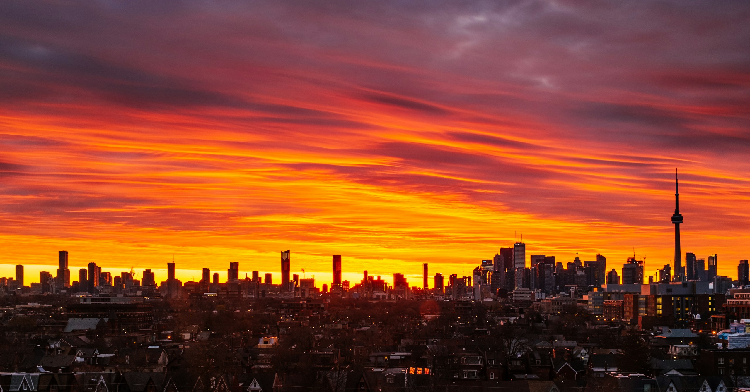 Toronto city skyline during a fiery orange sunset HD Wallpaper