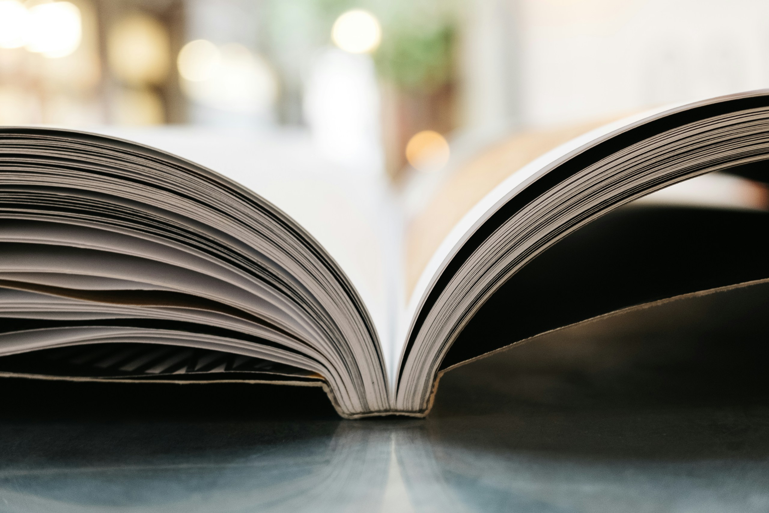 Close-Up of an Open Book with Bokeh Background HD Wallpaper