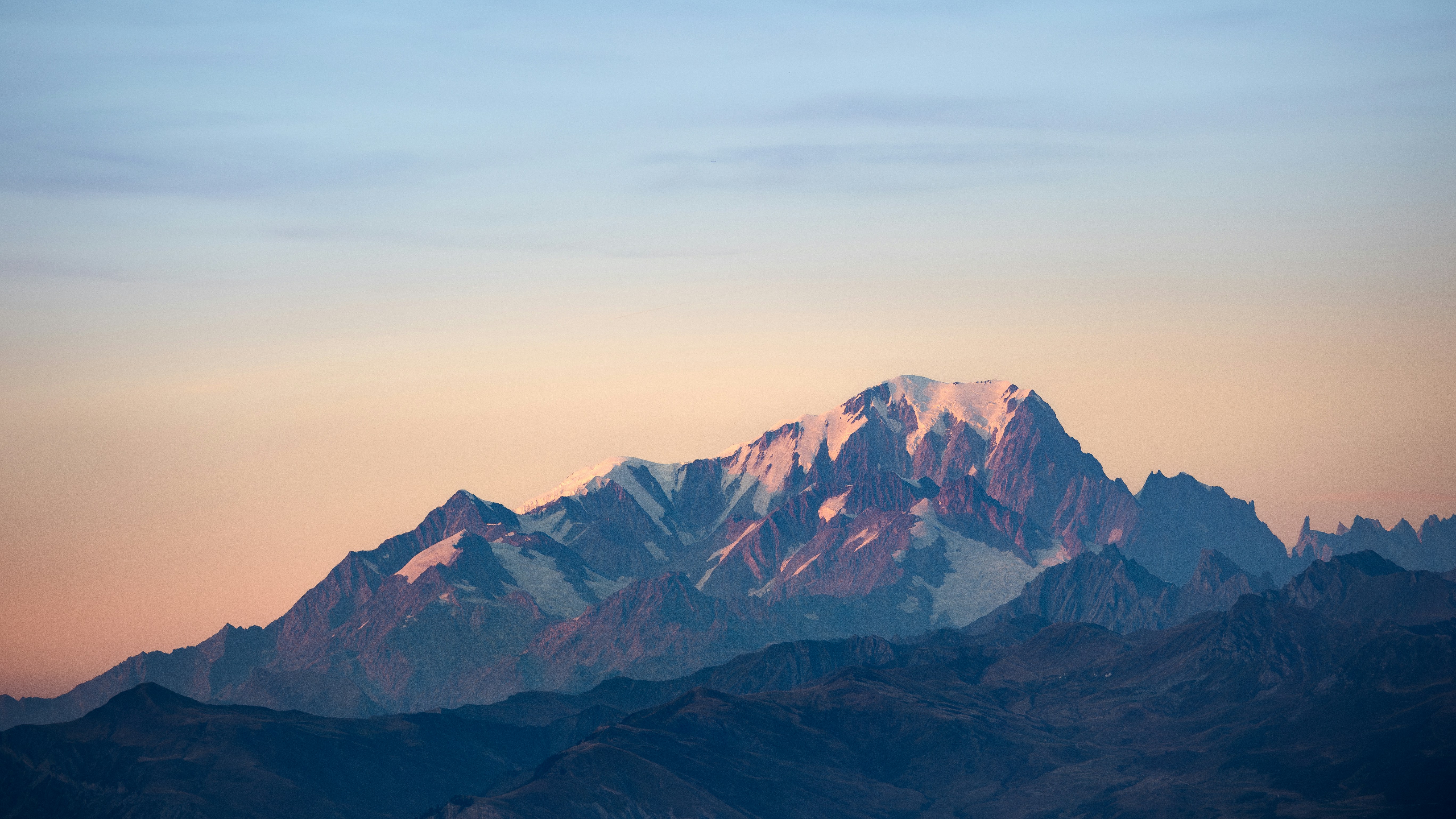 Snow-capped mountain peak during sunset HD Wallpaper