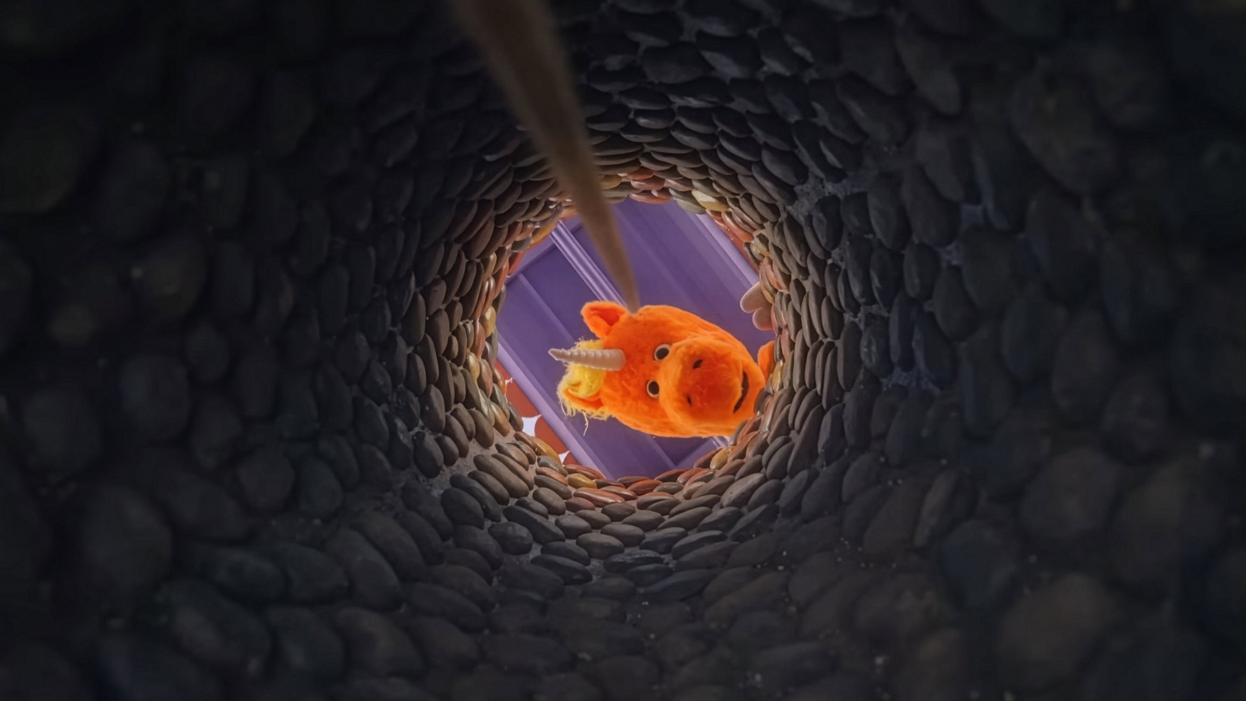 Orange puppet unicorn Buddy looking down a well HD Wallpaper
