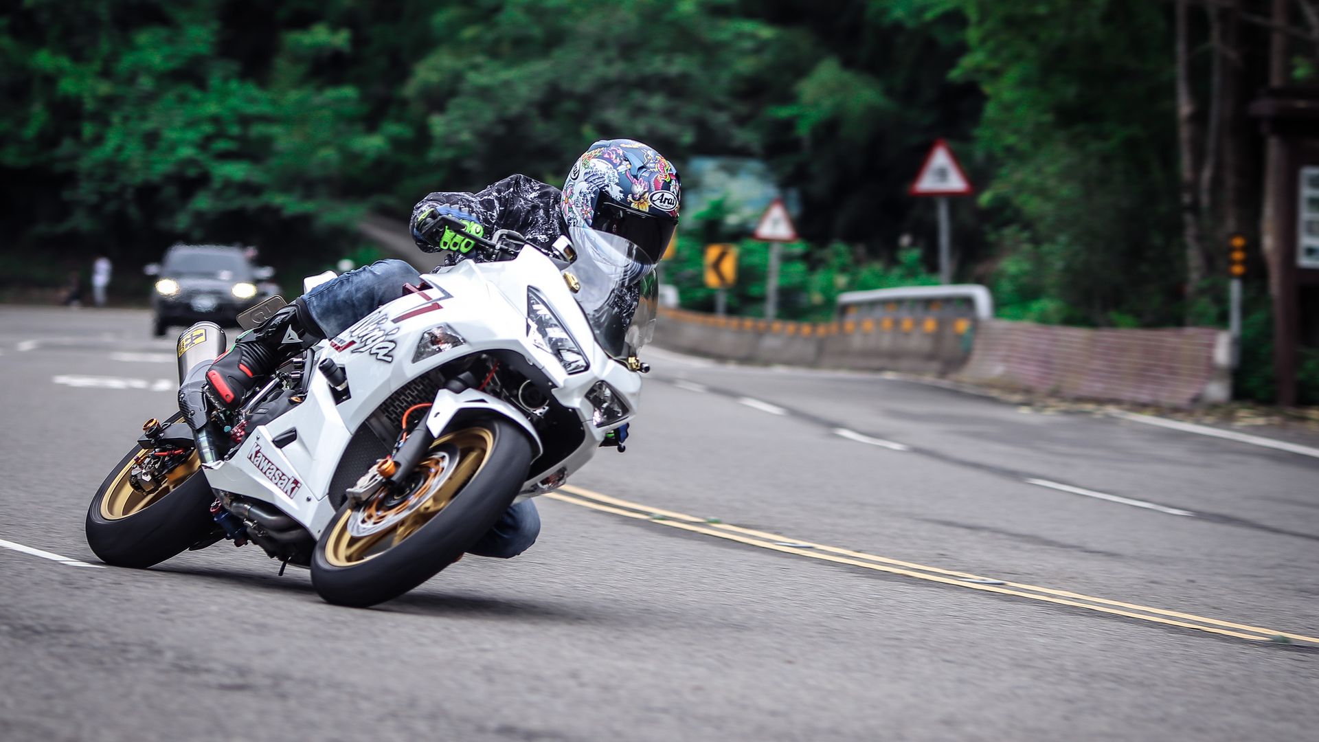 White Kawasaki Ninja Motorcycle Leaning on a Curved Road HD Wallpaper