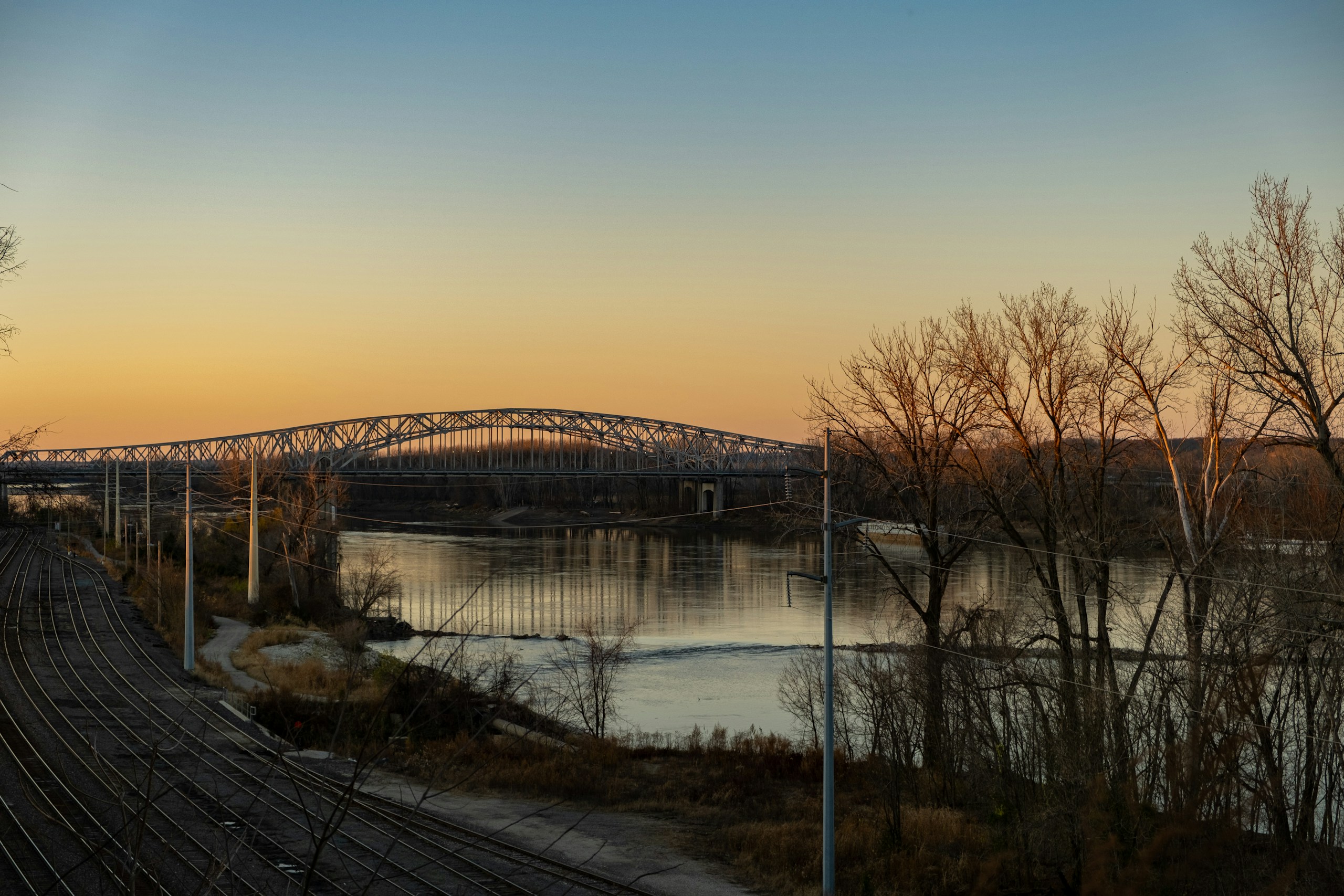 Steel Arch Bridge Over River at Sunset HD Wallpaper