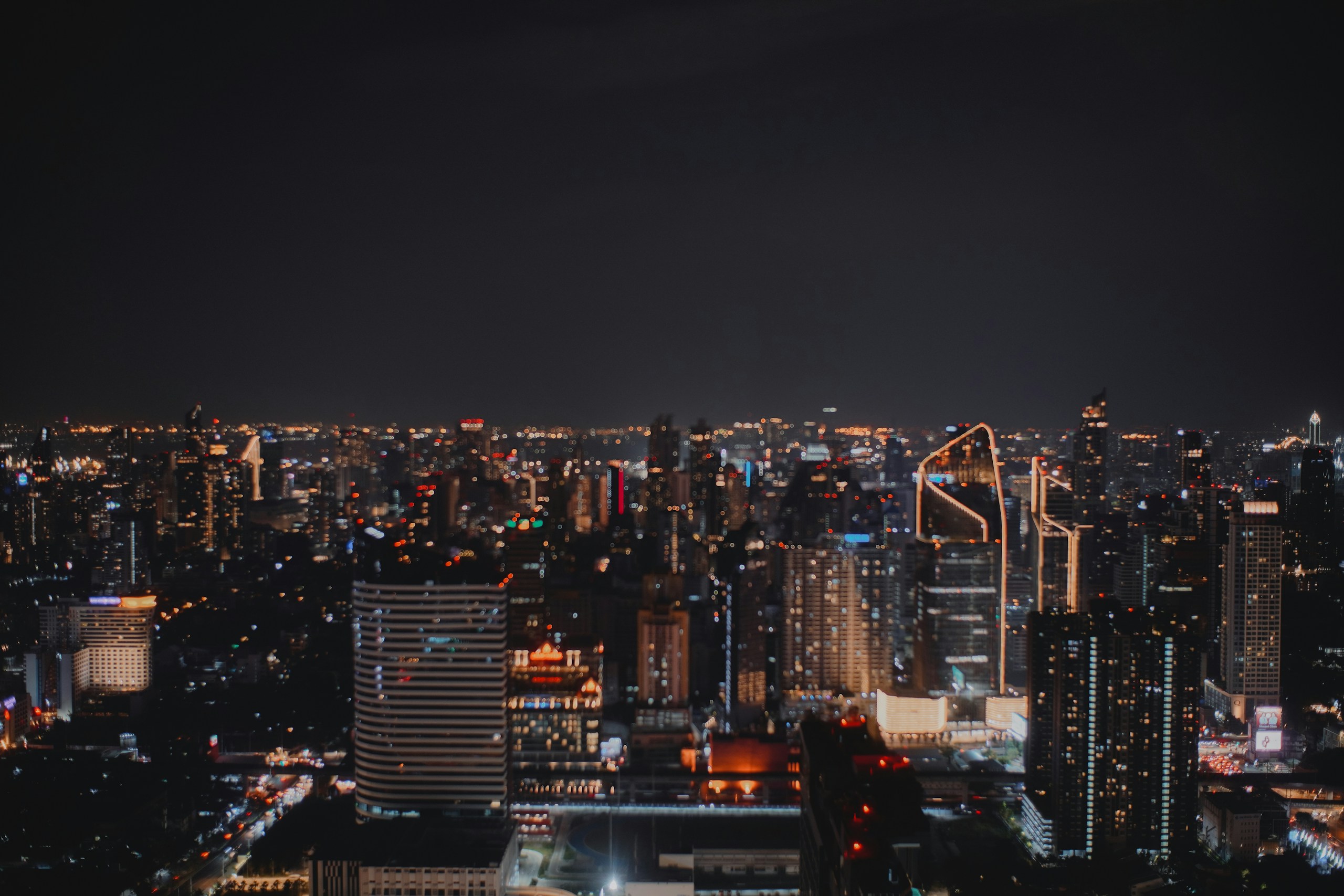 City Skyline at Night with Glowing Lights HD Wallpaper