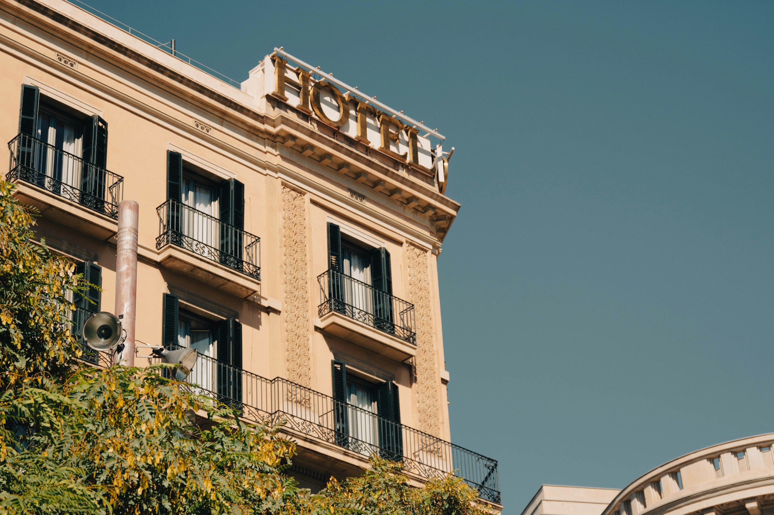 Classic Hotel Building Facade with Gold Sign HD Wallpaper