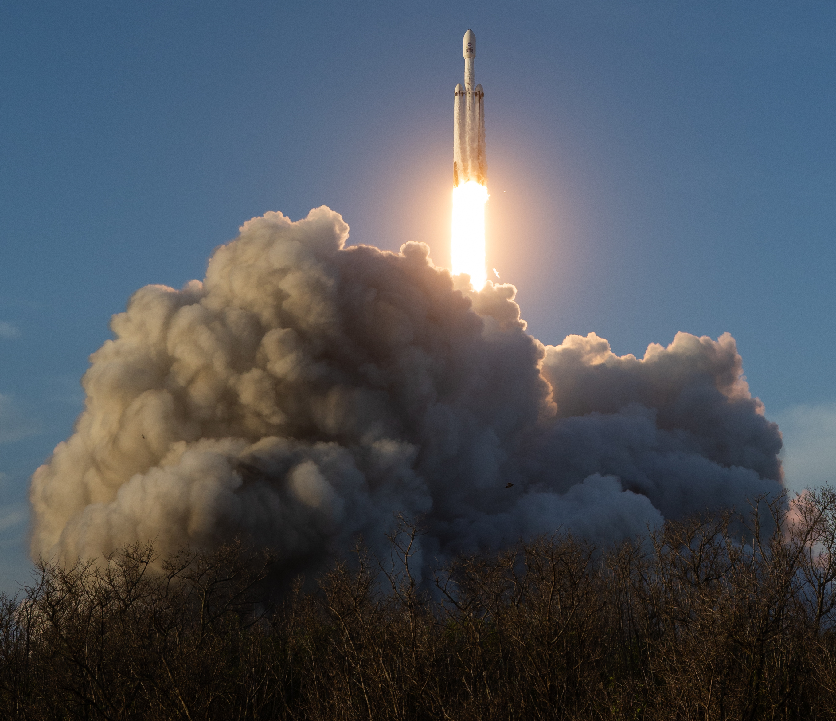 SpaceX Falcon Heavy Rocket Launching into Blue Sky HD Wallpaper