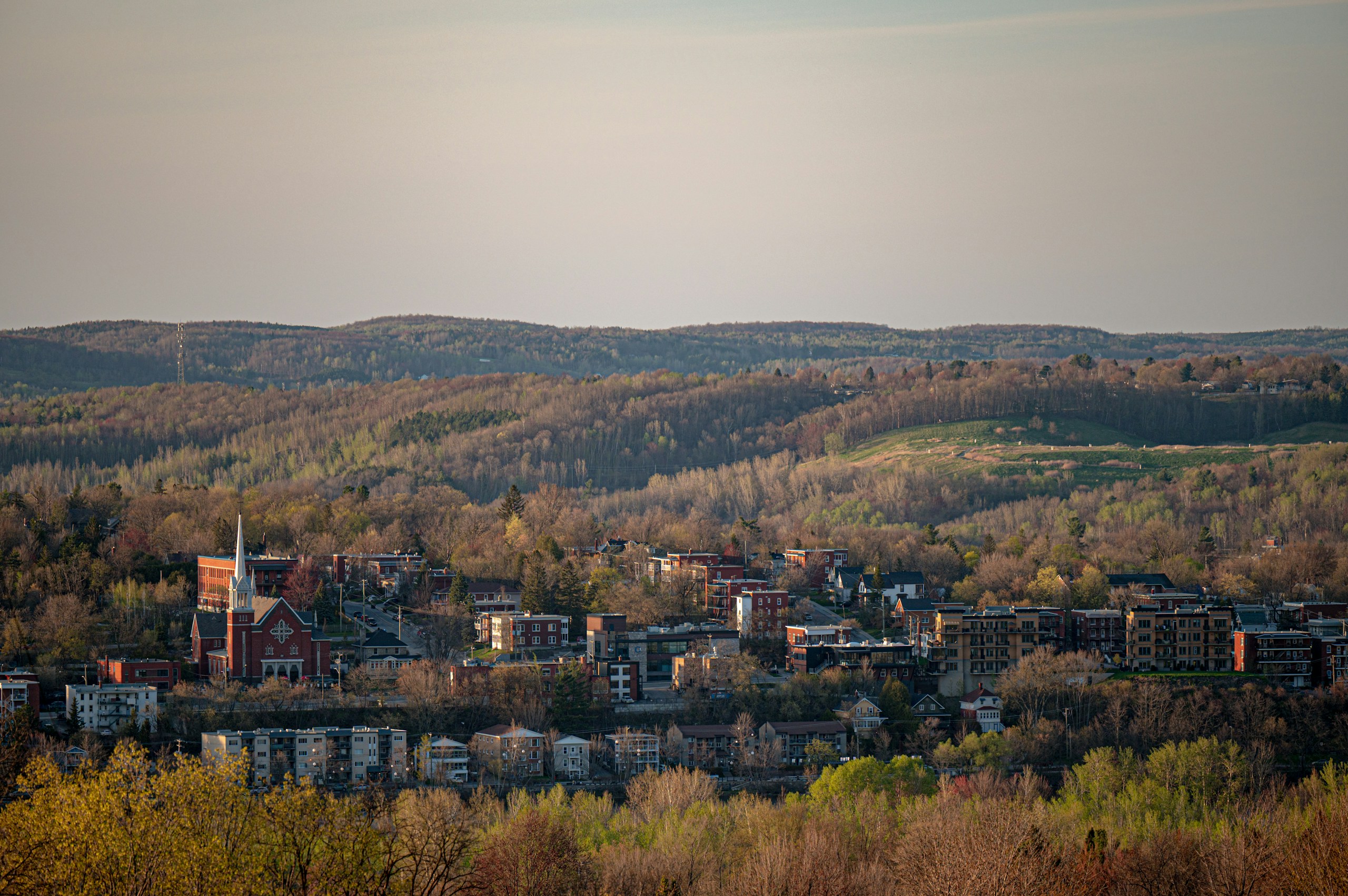 Small Town Nestled in a Forested Valley HD Wallpaper