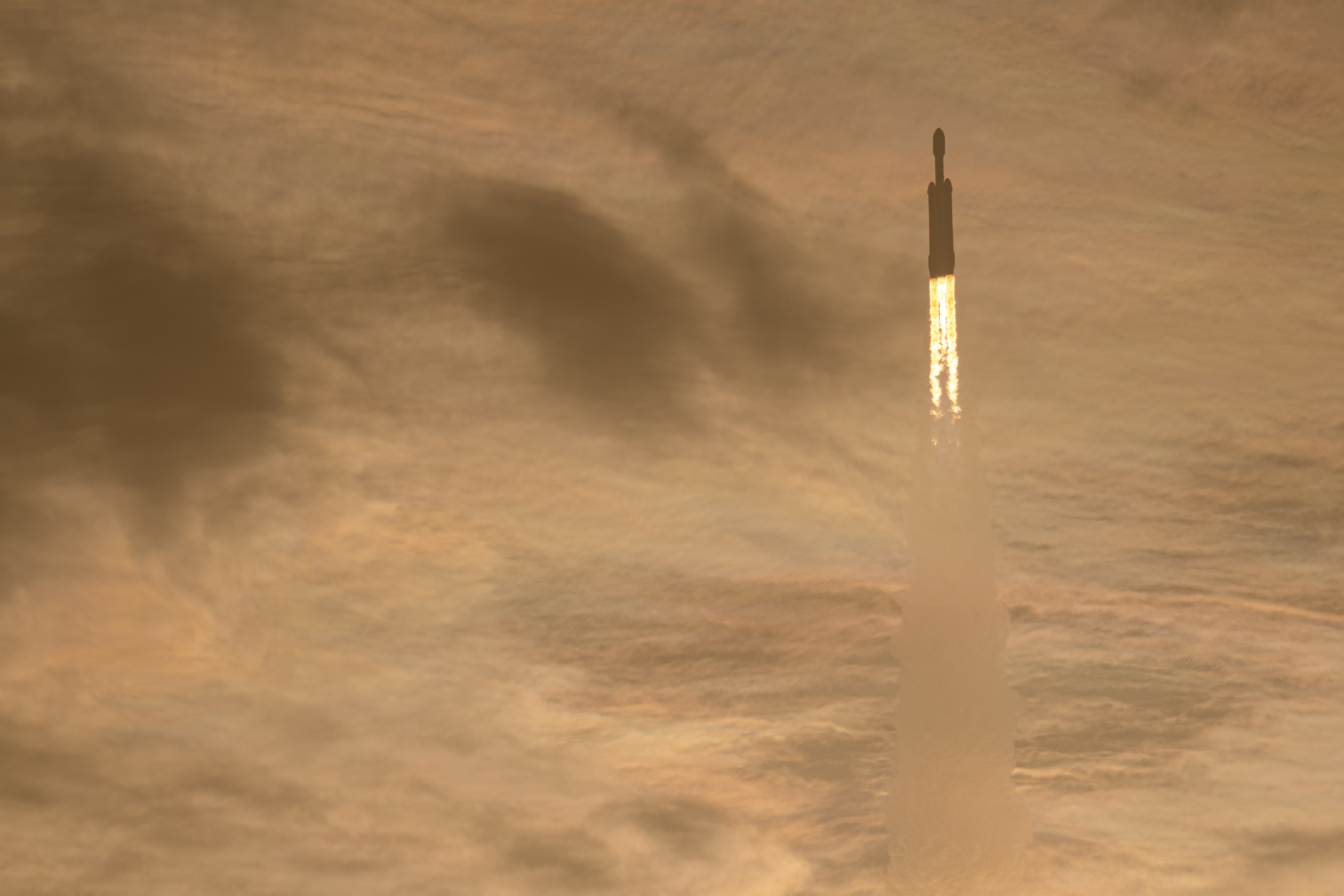 SpaceX Falcon Heavy Rocket Launching into Golden Clouds HD Wallpaper