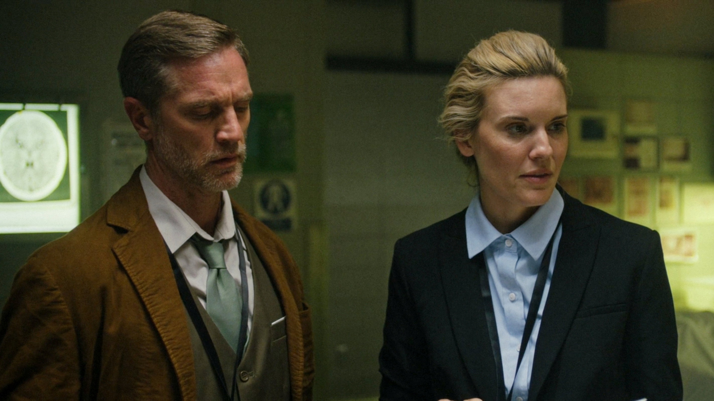 Two detectives in a dimly lit room HD Wallpaper