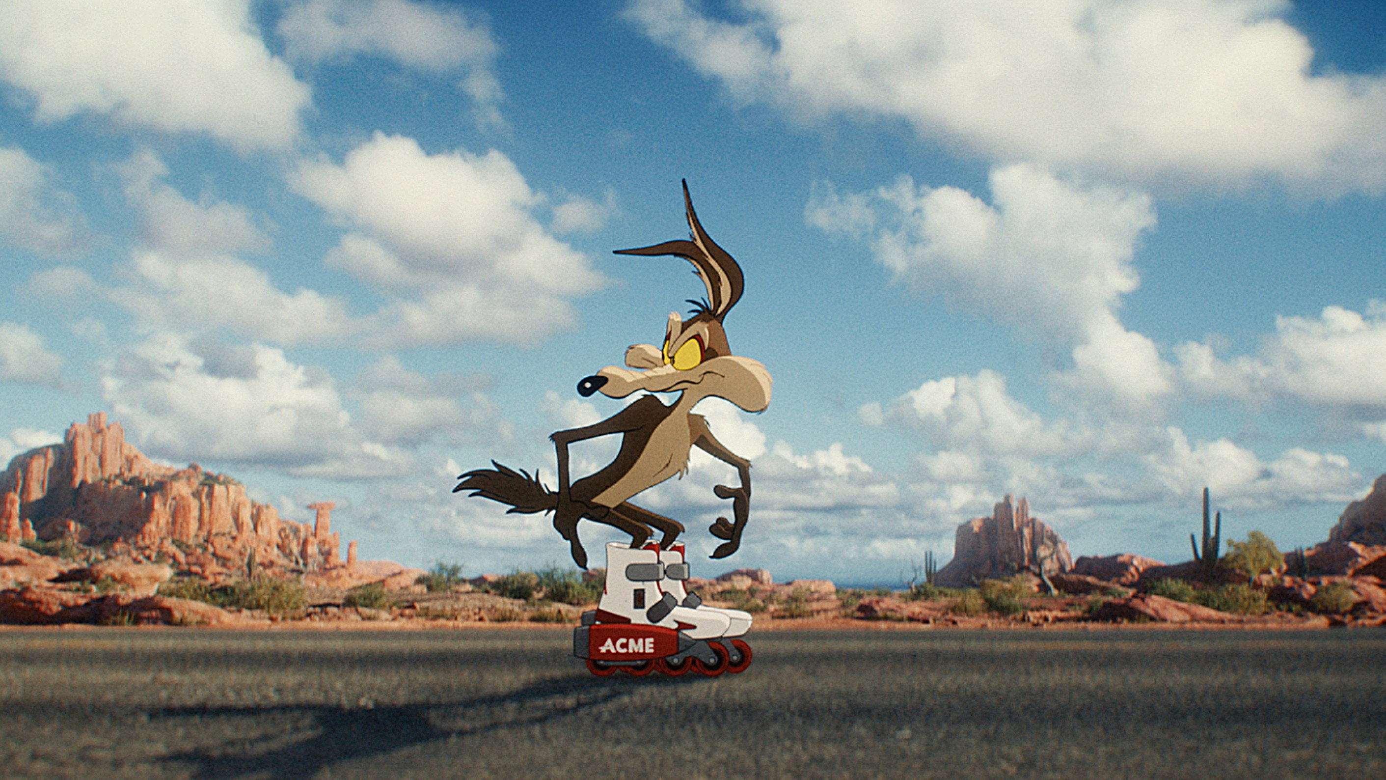 Wile E. Coyote on roller skates in desert HD Wallpaper