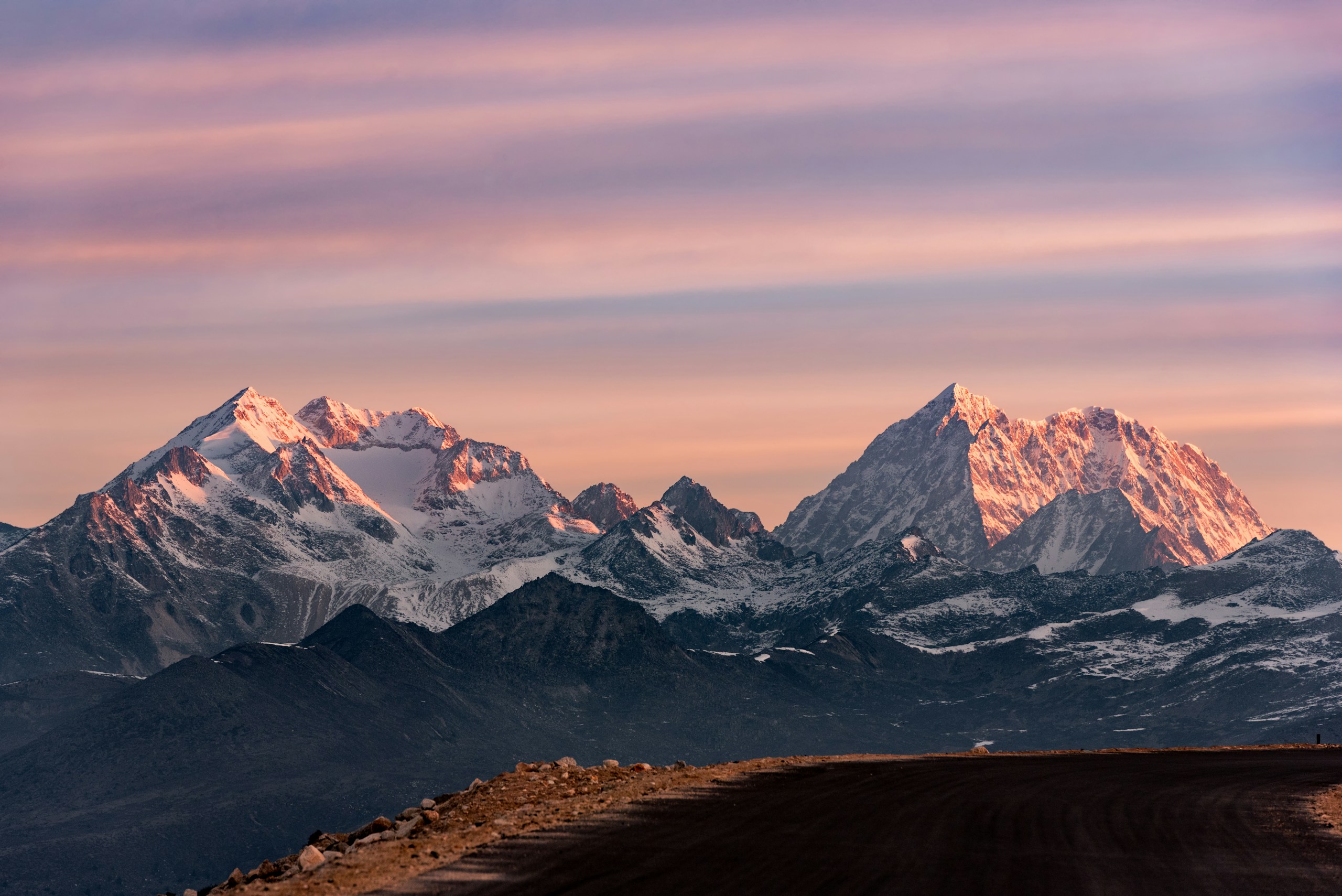Snow-capped mountains at sunrise with pink sky HD Wallpaper