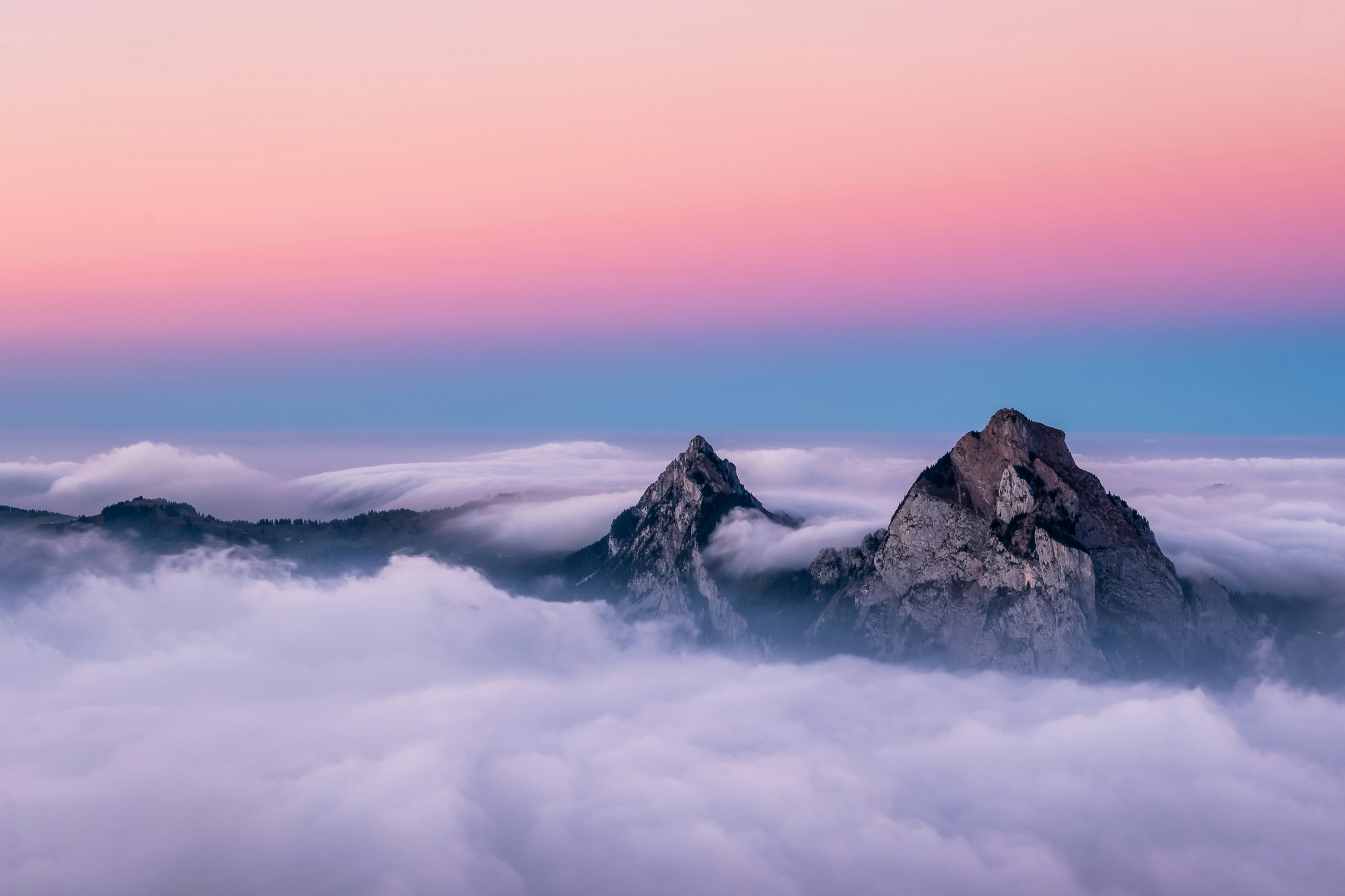 Mountain peaks above clouds at sunset HD Wallpaper