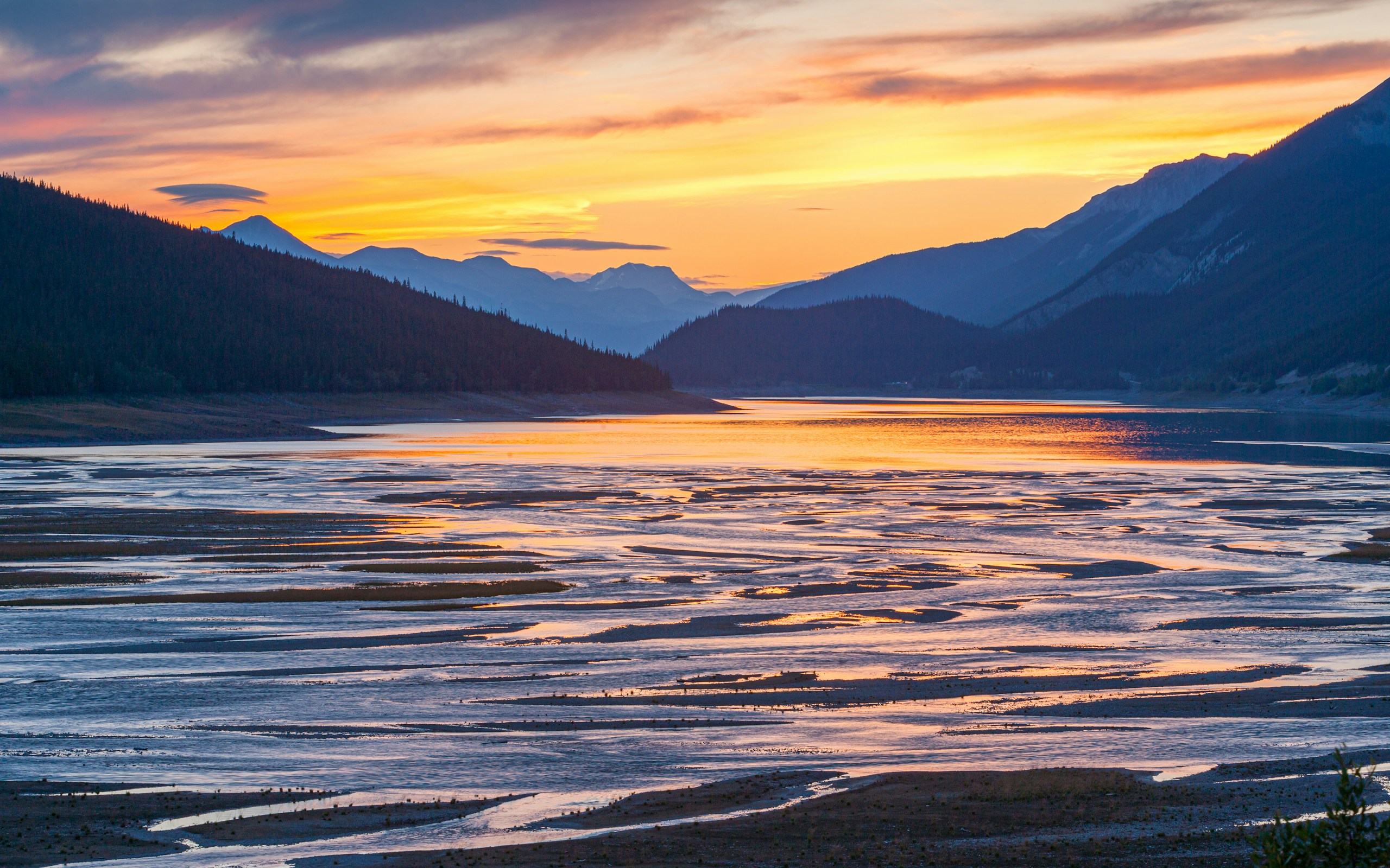 Sunset over a mountain lake with exposed sandbars HD Wallpaper