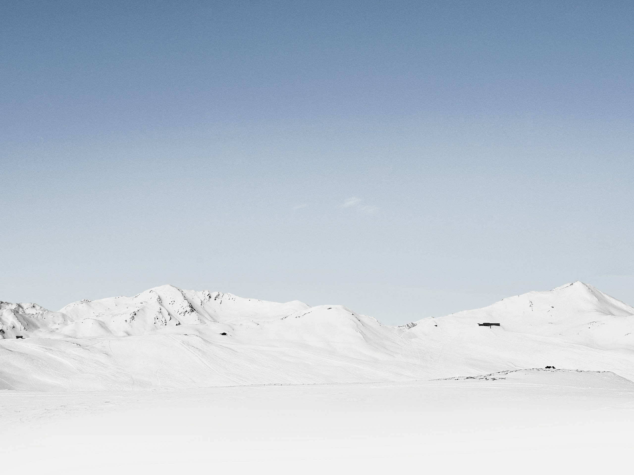 Snow-covered mountains under a clear blue sky HD Wallpaper