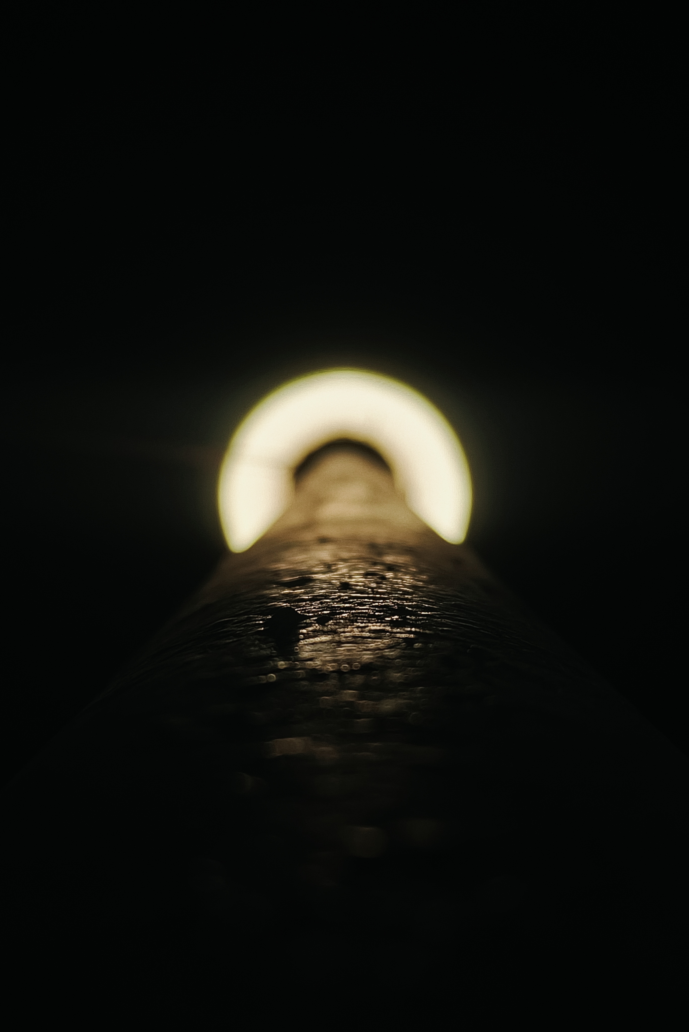 Close-up of a textured pipe with light at the end HD Wallpaper