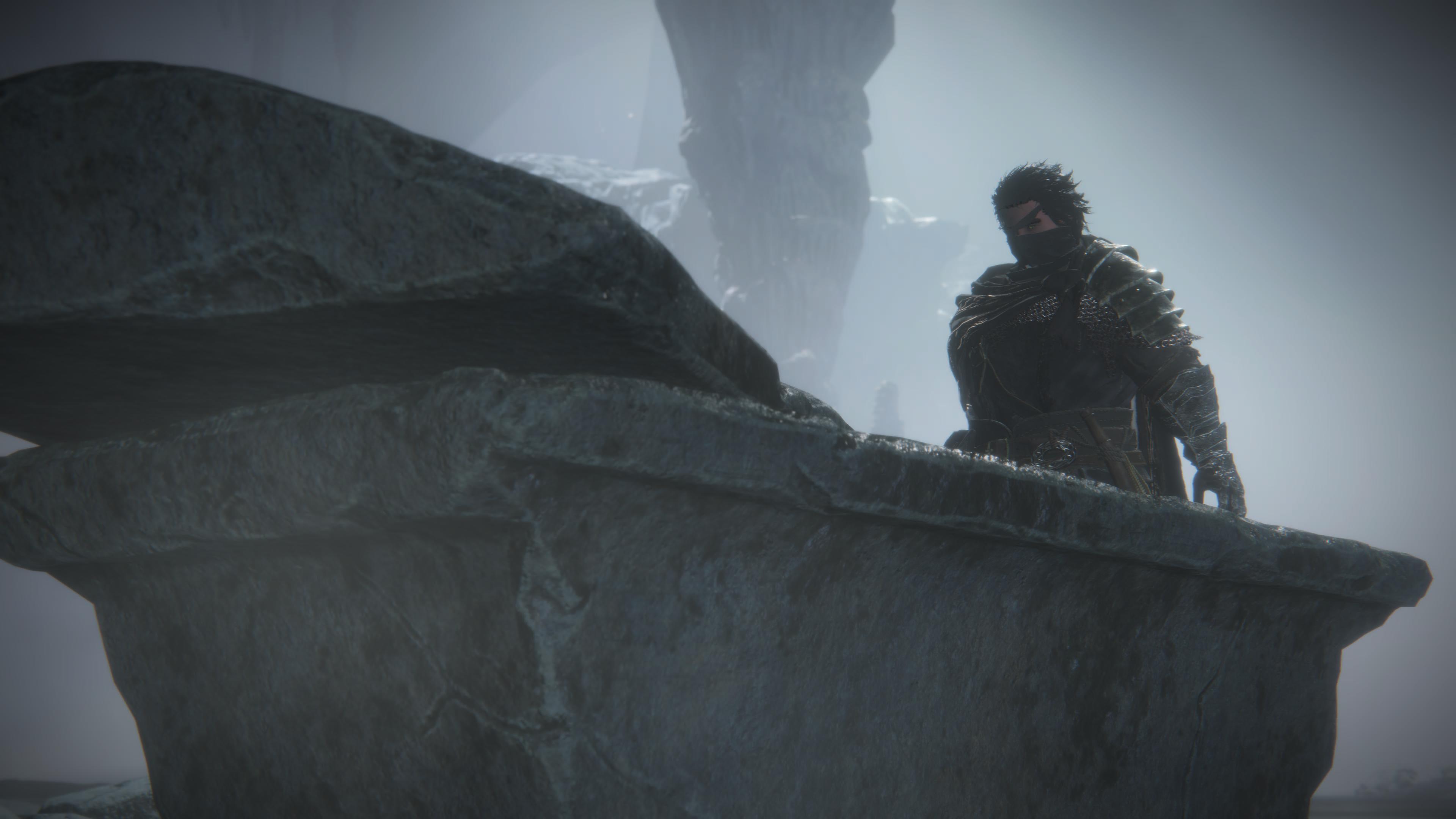 Man in armor on rocky outcrop in misty environment HD Wallpaper