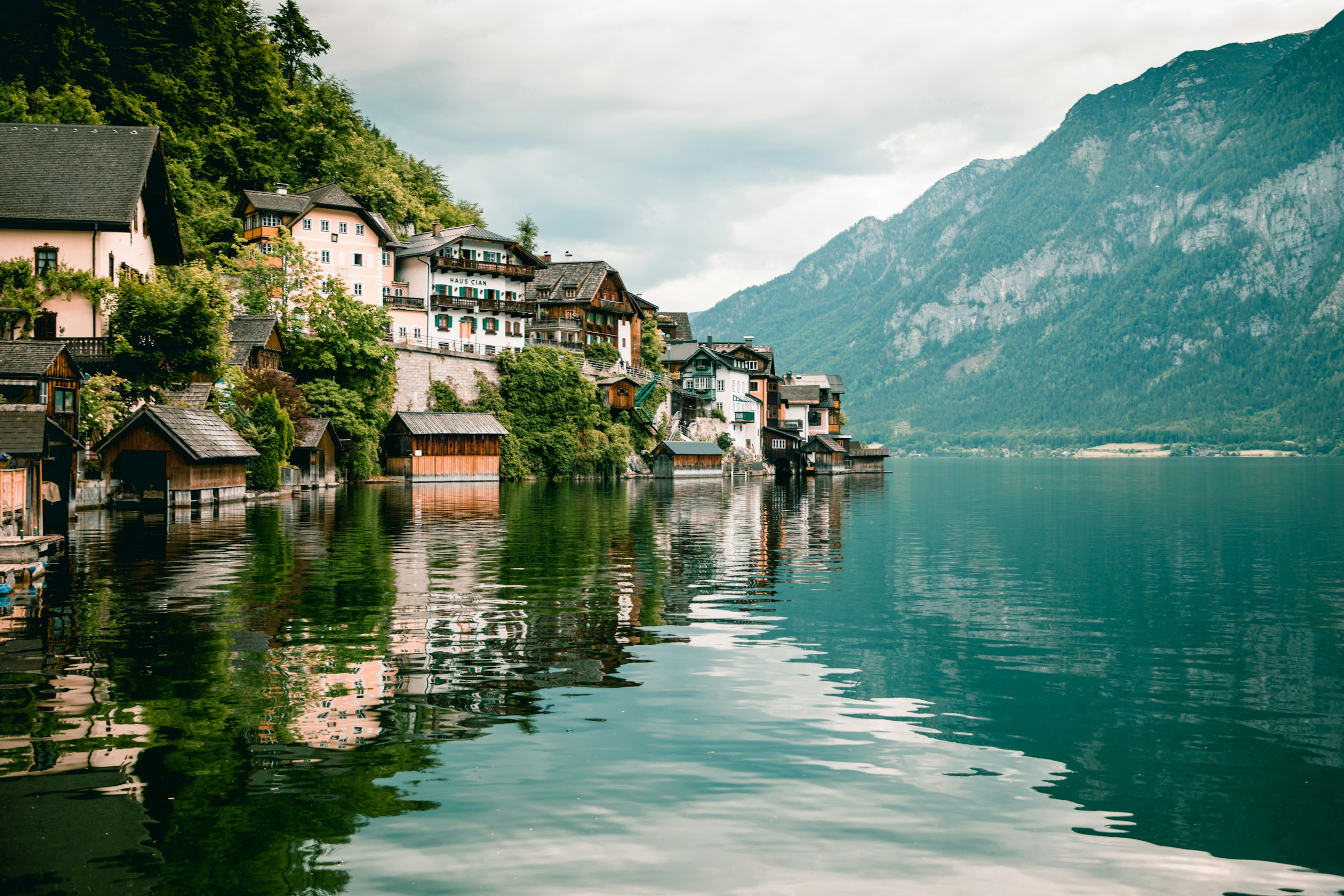 Hallstatt village on a lake with mountains HD Wallpaper