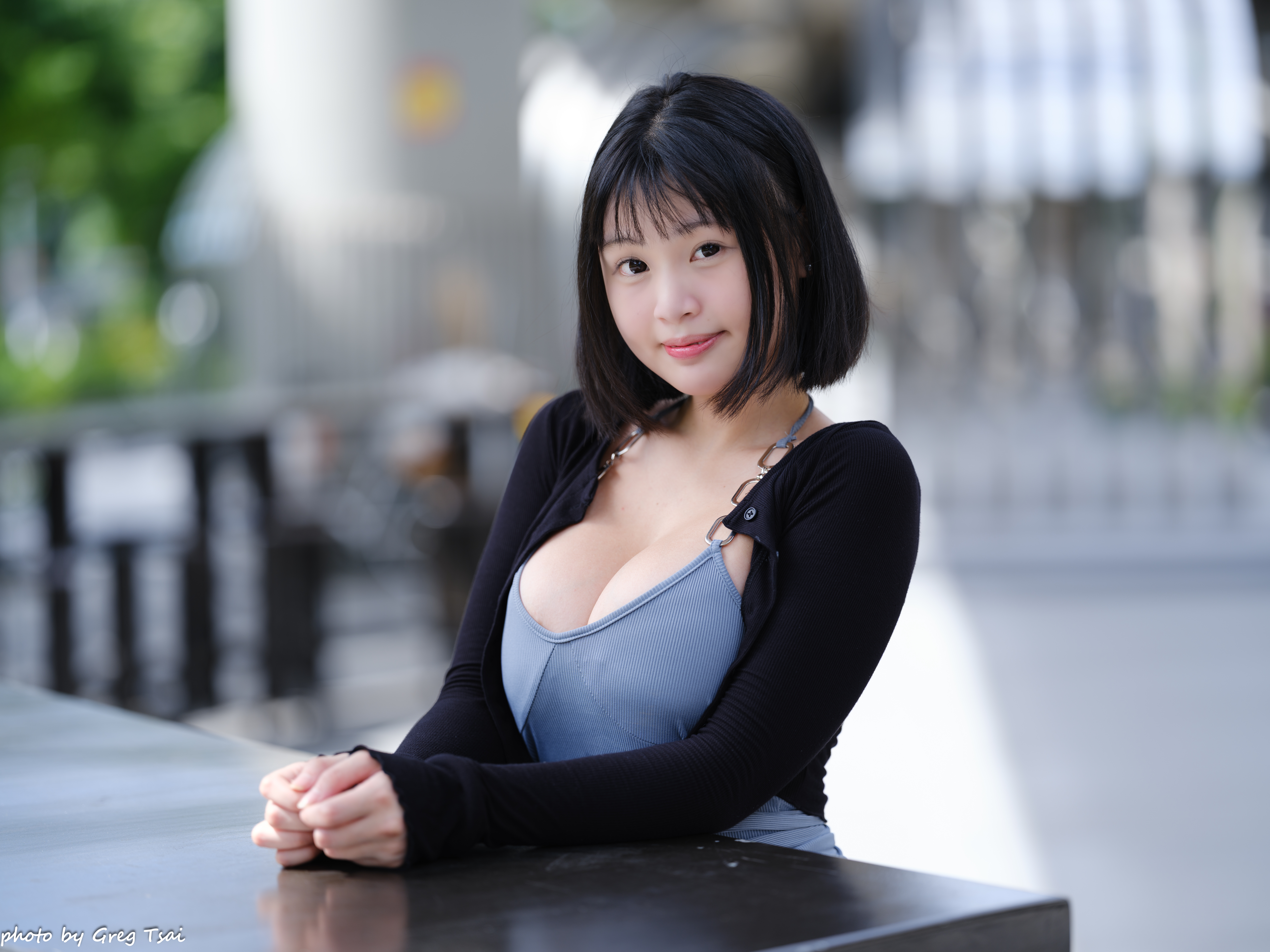 Young woman in a blue top and black cardigan HD Wallpaper