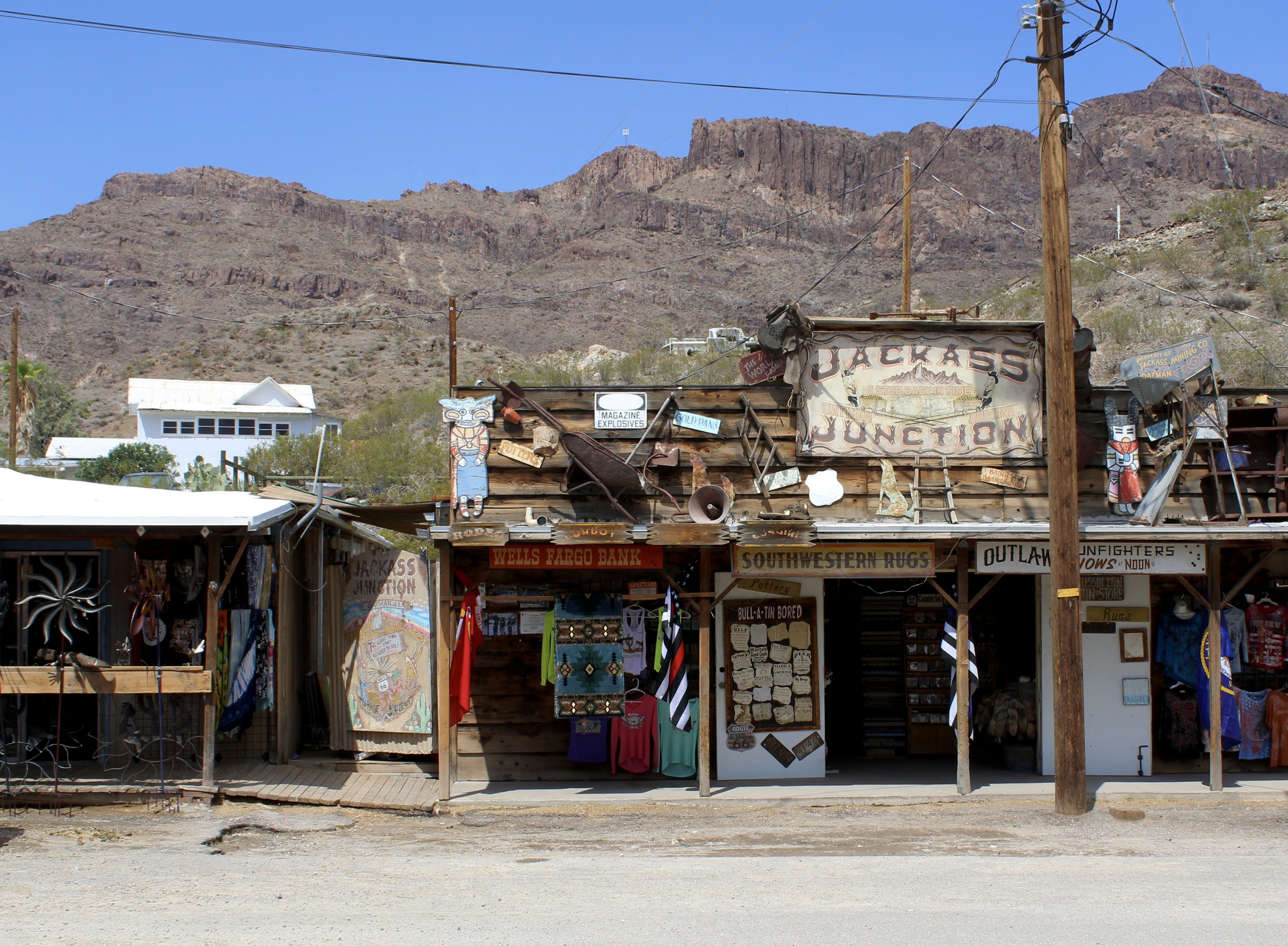 Old Western Town Shops with Mountains in Background HD Wallpaper