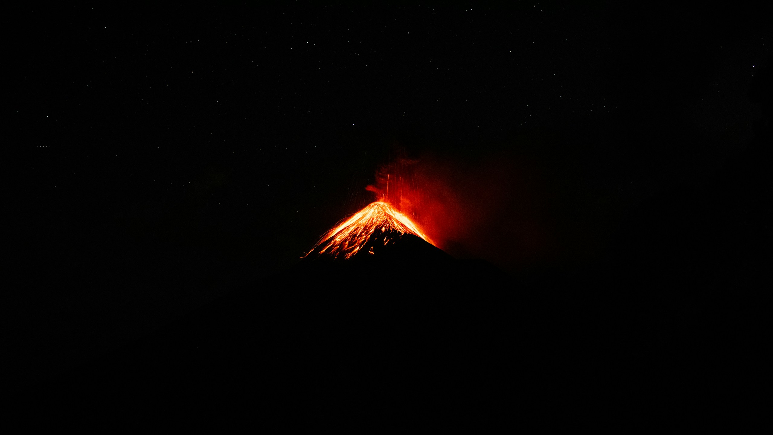 Volcano erupting at night with stars HD Wallpaper