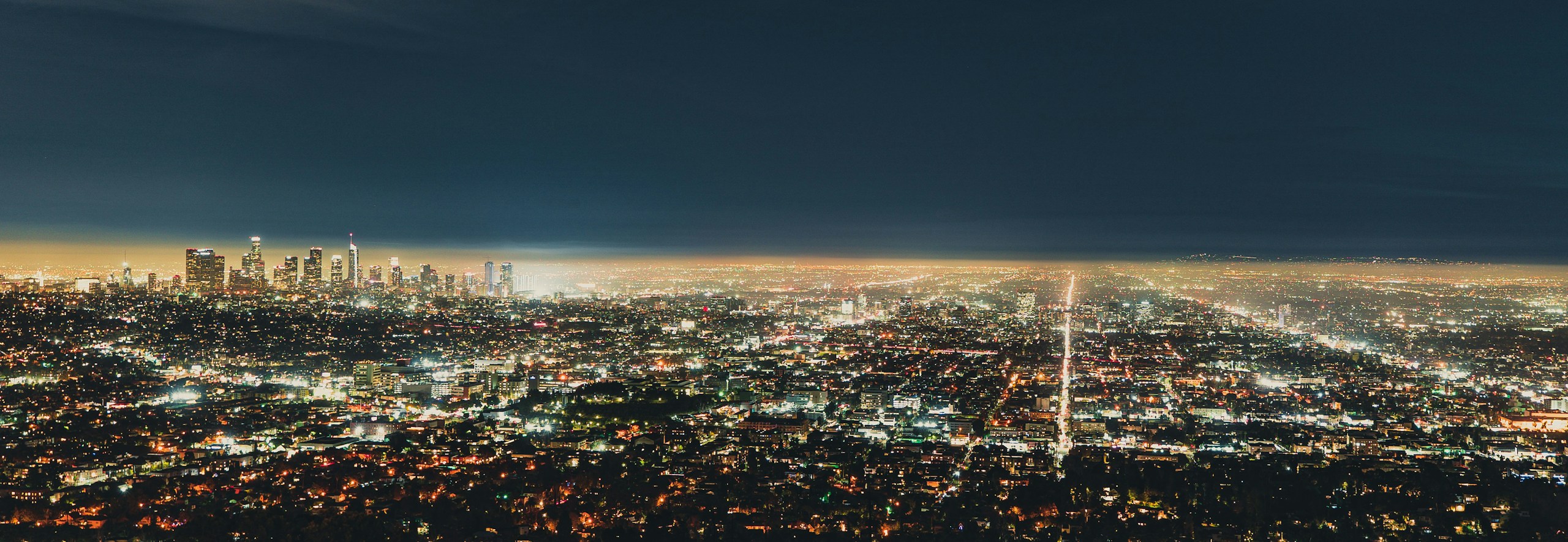 Aerial view of a city at night HD Wallpaper