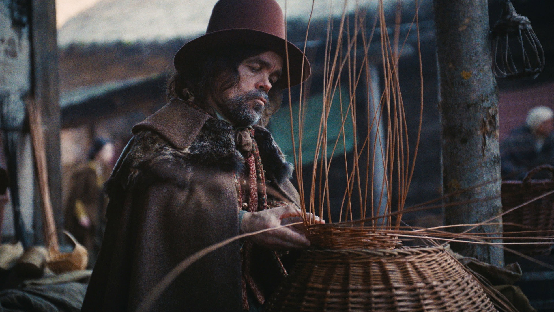 Man weaving a basket in a historical setting HD Wallpaper