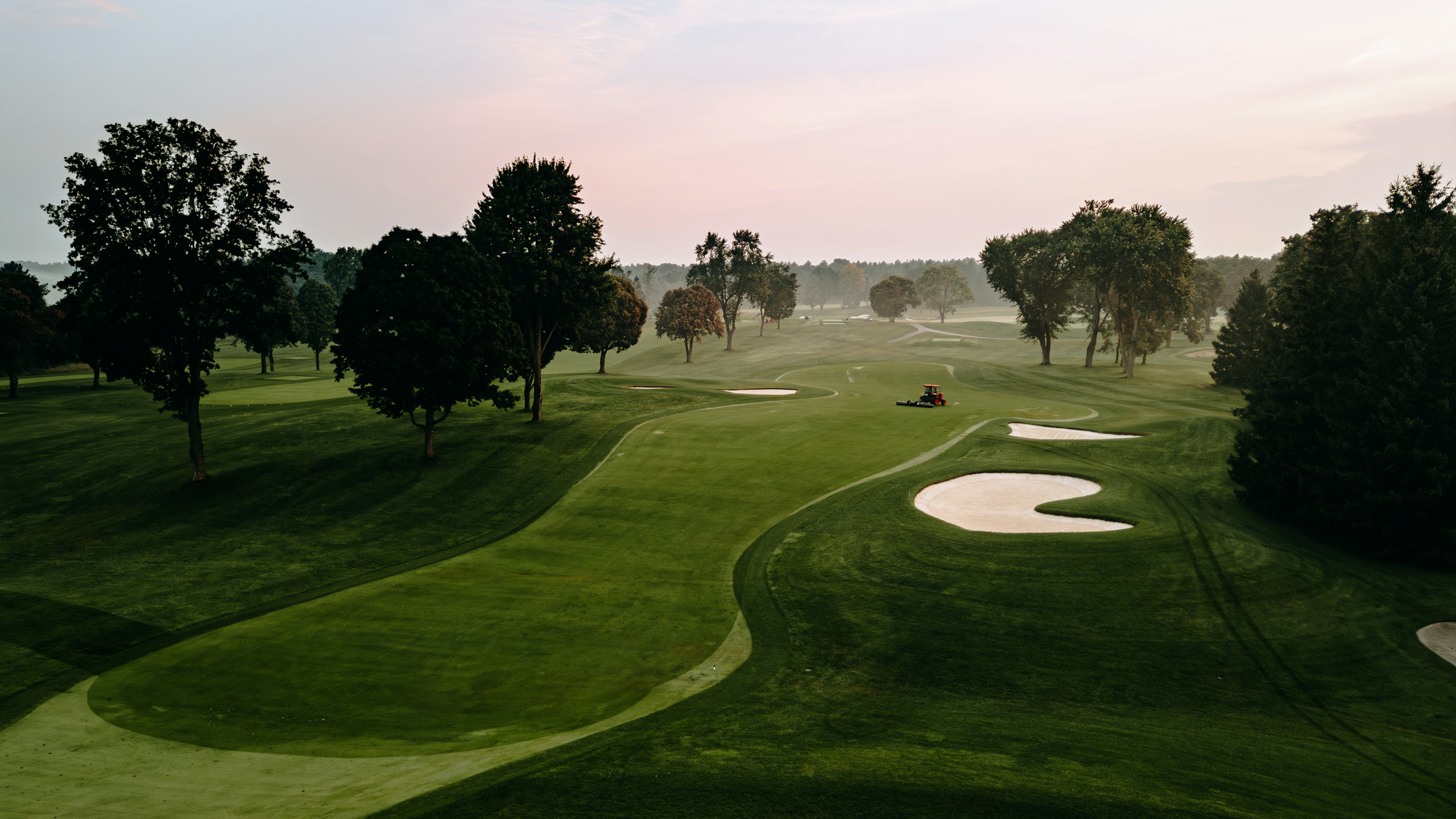Golf course with trees and a lawn mower HD Wallpaper