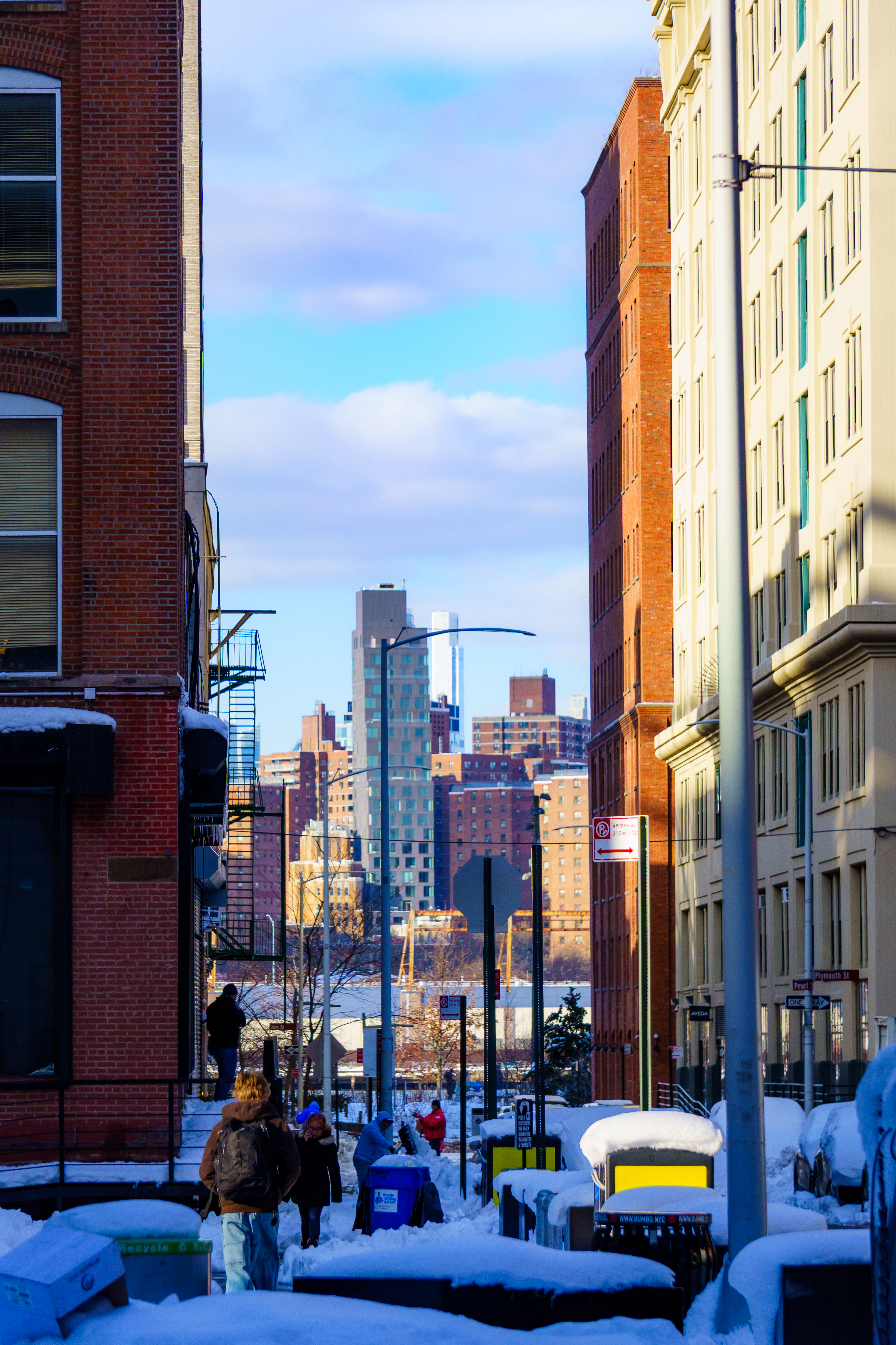 Snowy street with people and city skyline HD Wallpaper