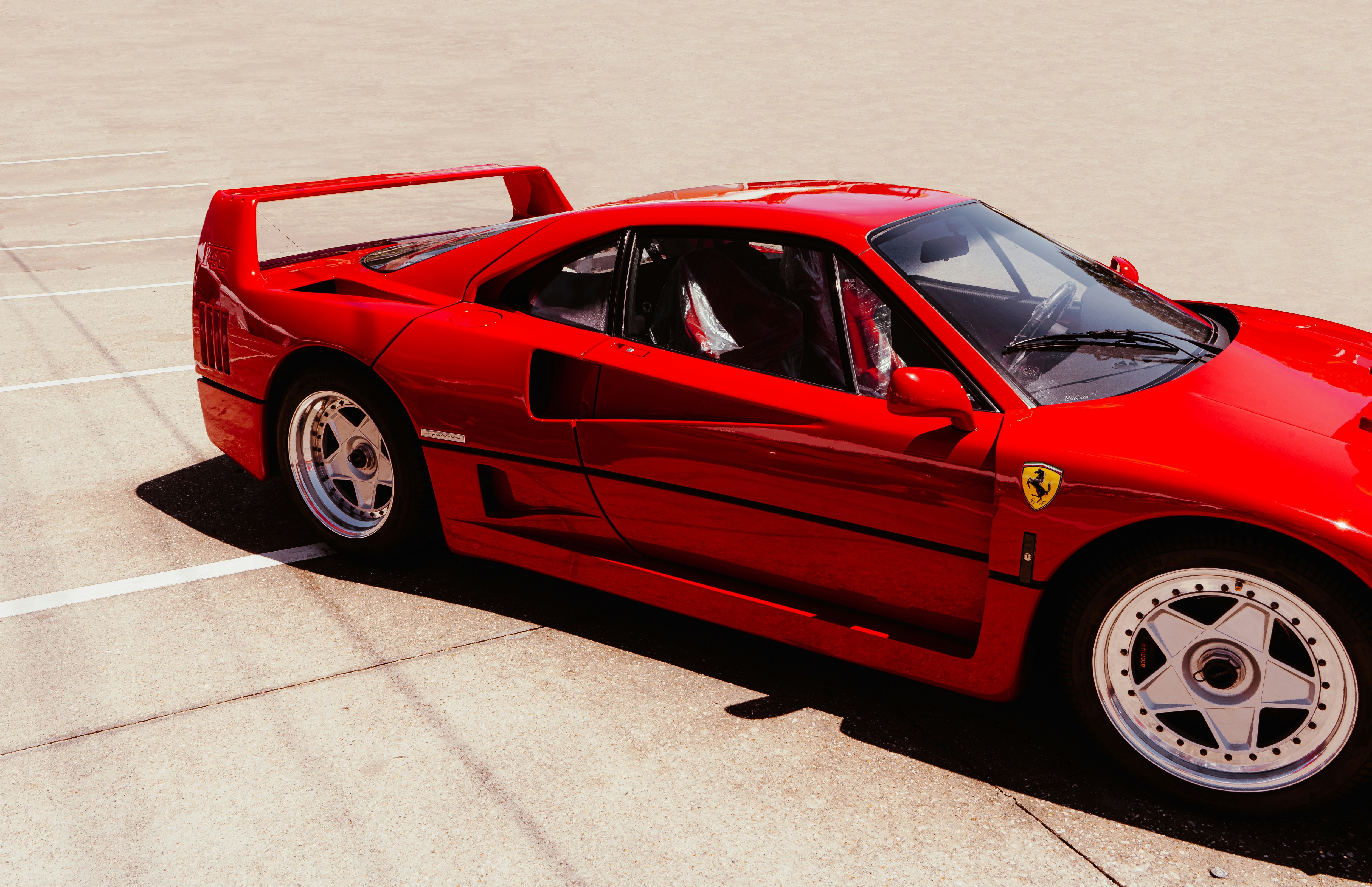 Red Ferrari F40 parked on concrete HD Wallpaper