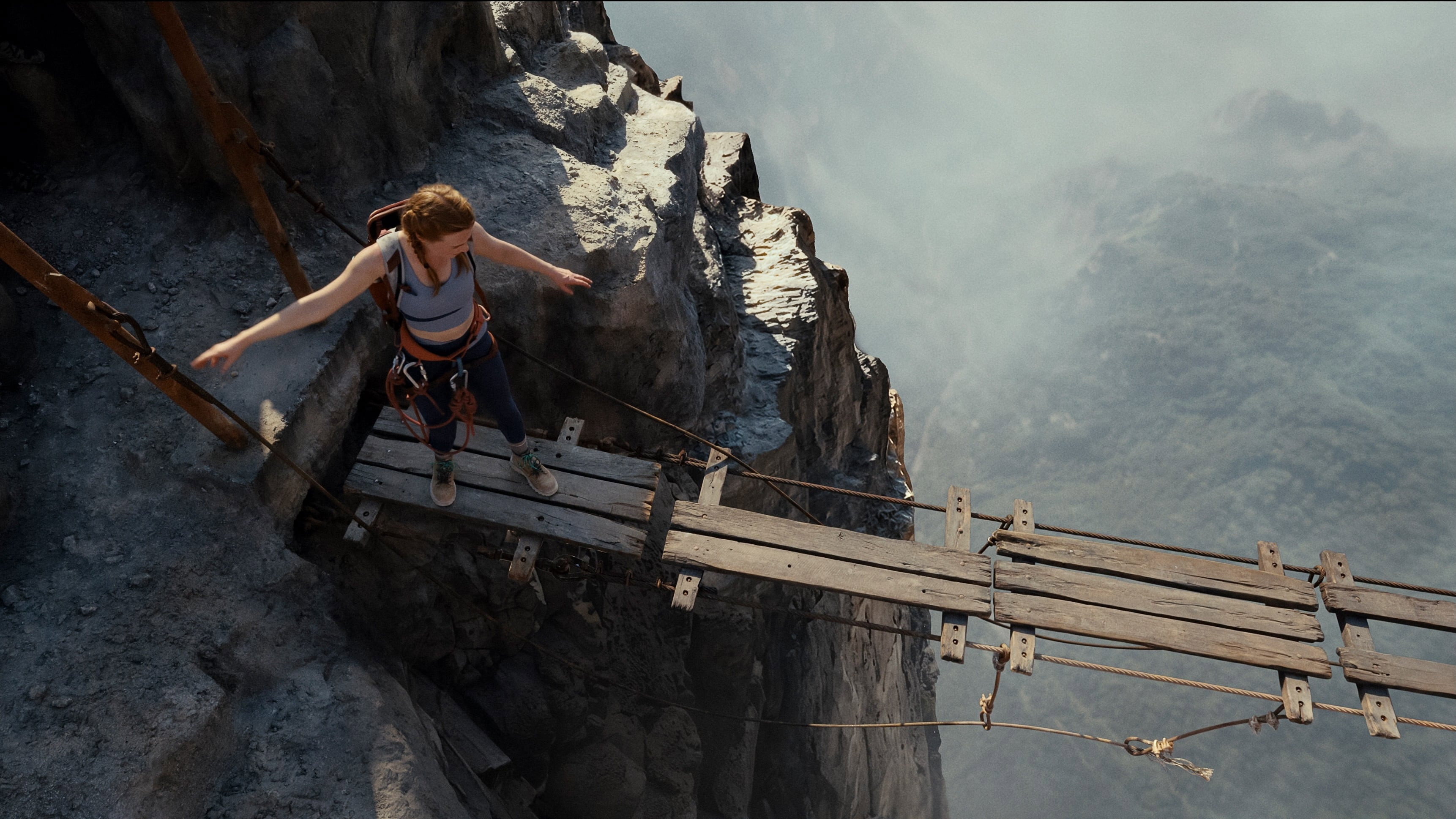 Woman on a precarious rope bridge HD Wallpaper
