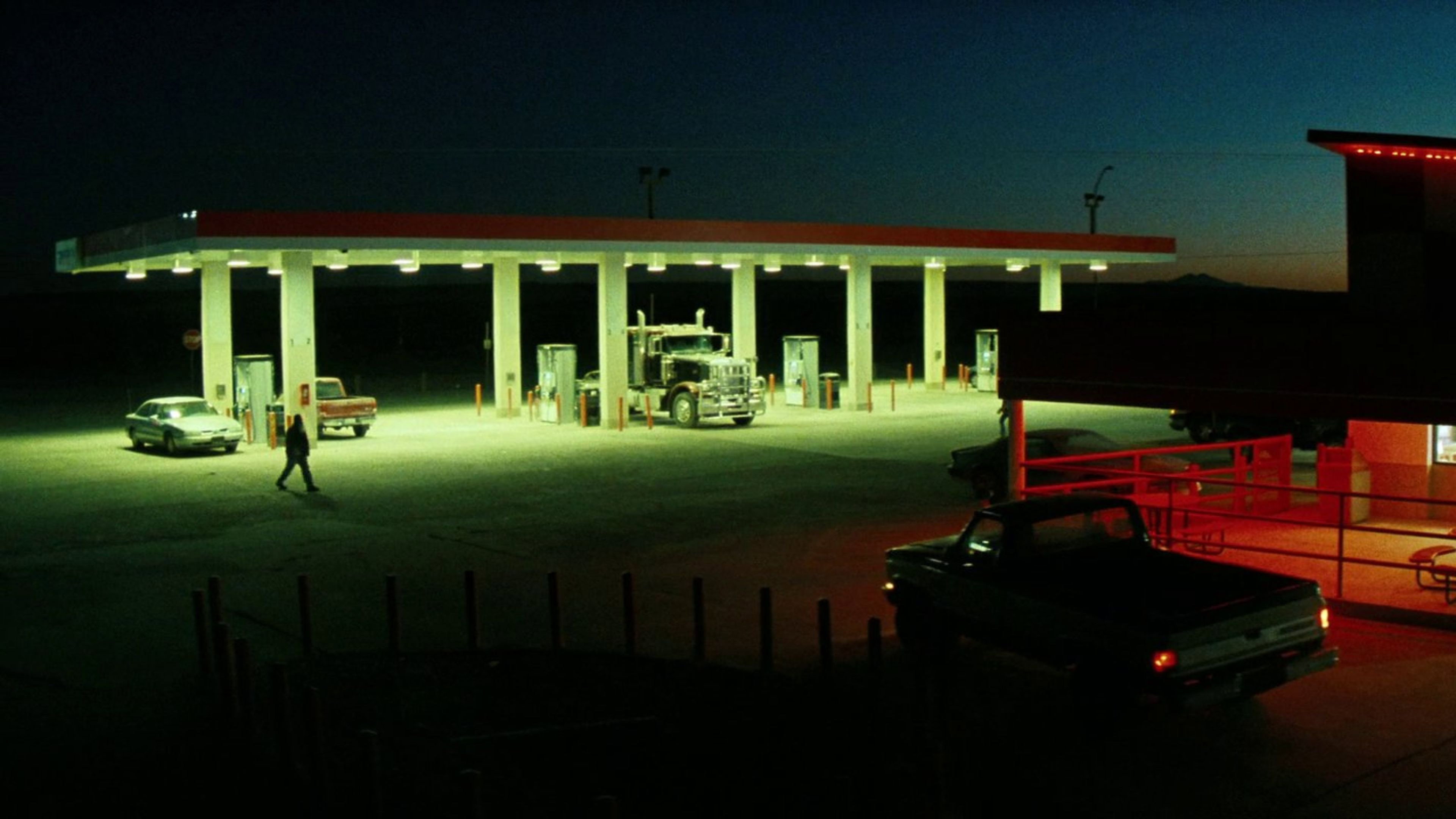 Gas station at night with trucks and cars HD Wallpaper