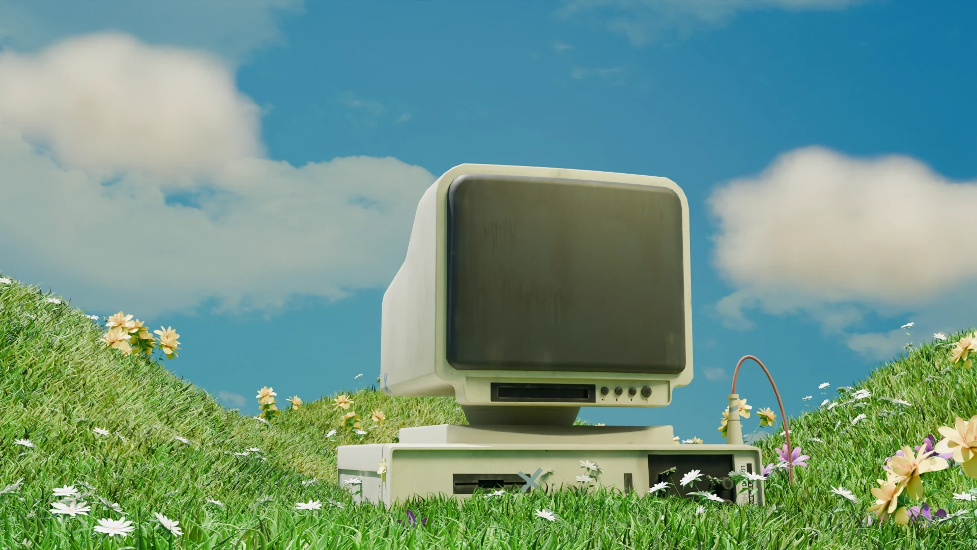 Retro computer in a grassy field with flowers HD Wallpaper