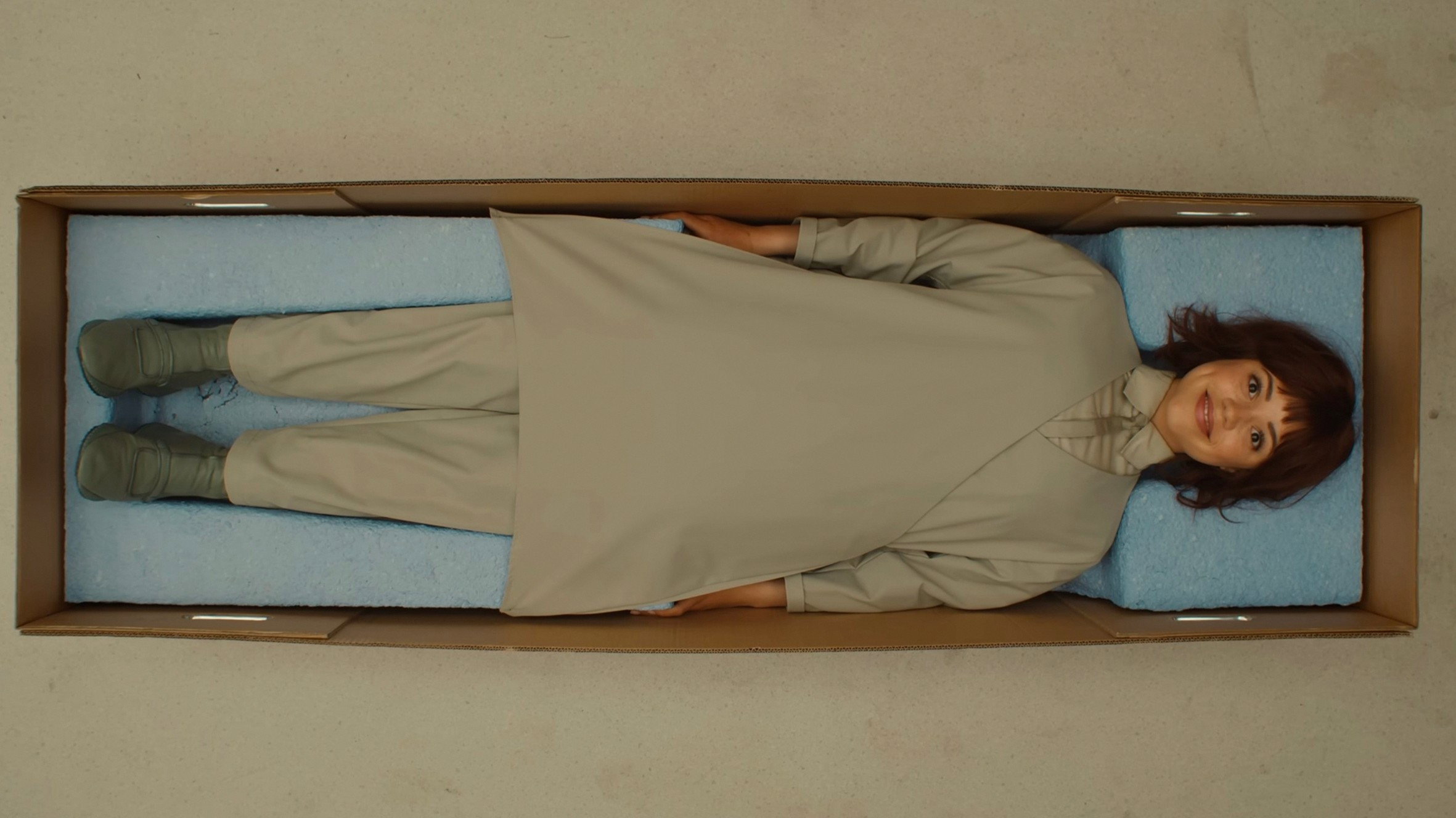 Woman in a box with blue foam padding HD Wallpaper