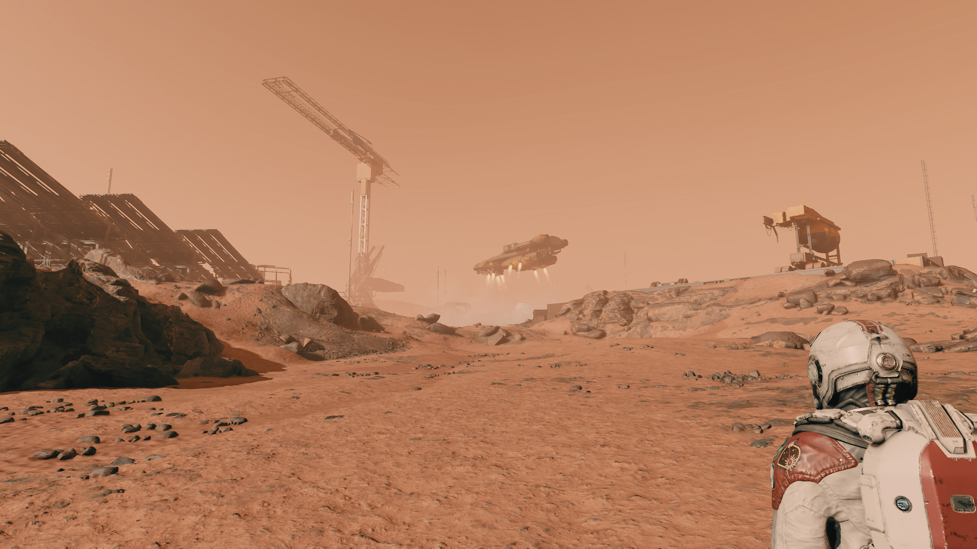 Astronaut on Mars observing a spaceship and construction site HD Wallpaper