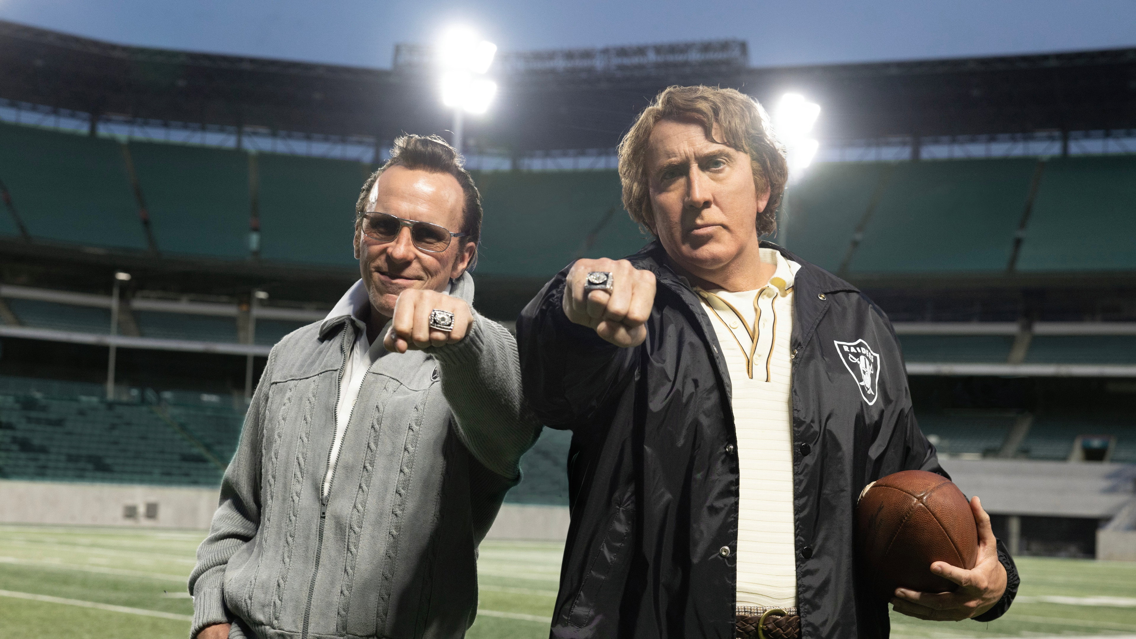 Two men in football stadium with rings HD Wallpaper