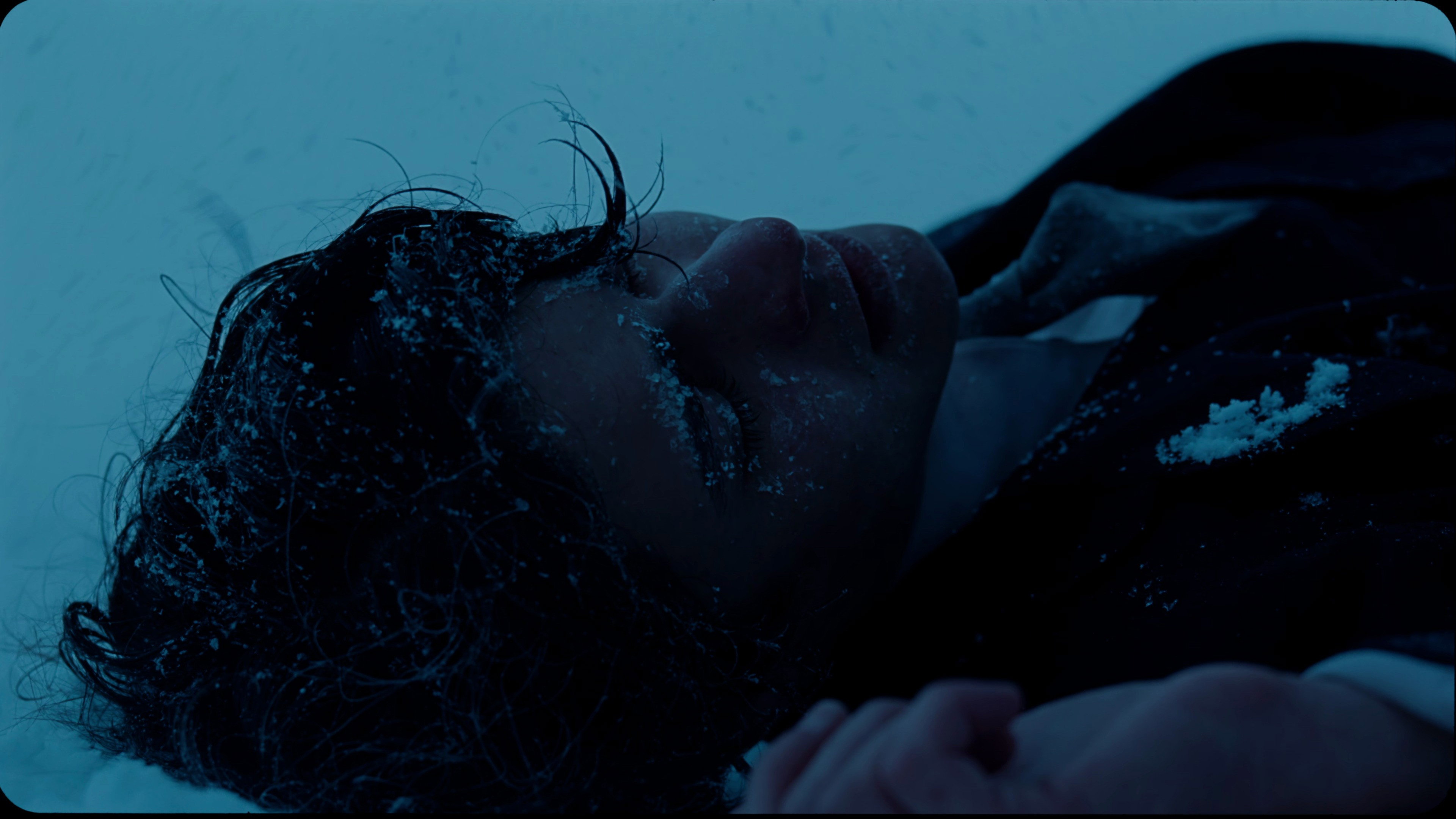 Person lying in snow, covered in frost HD Wallpaper