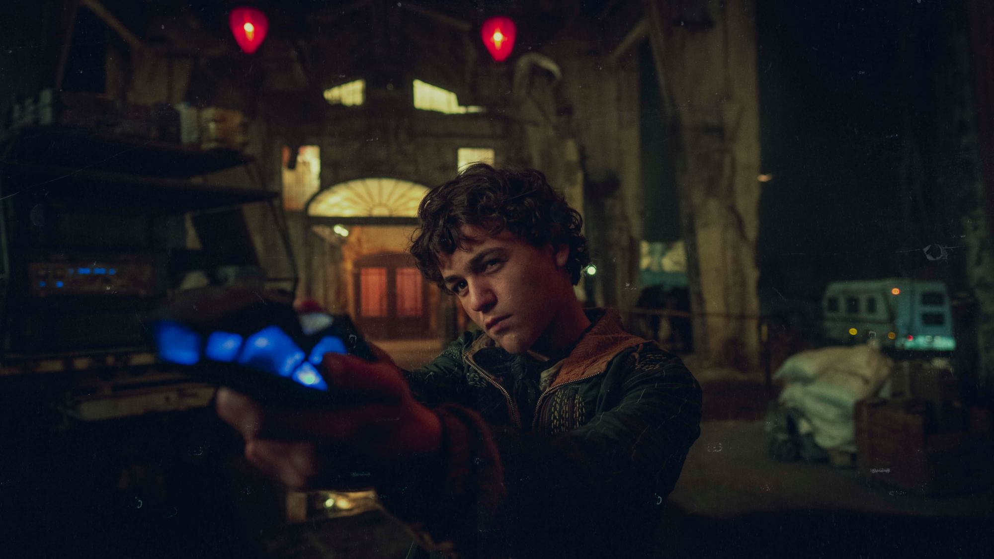 Young man holding a glowing device in Tribes of Europa HD Wallpaper