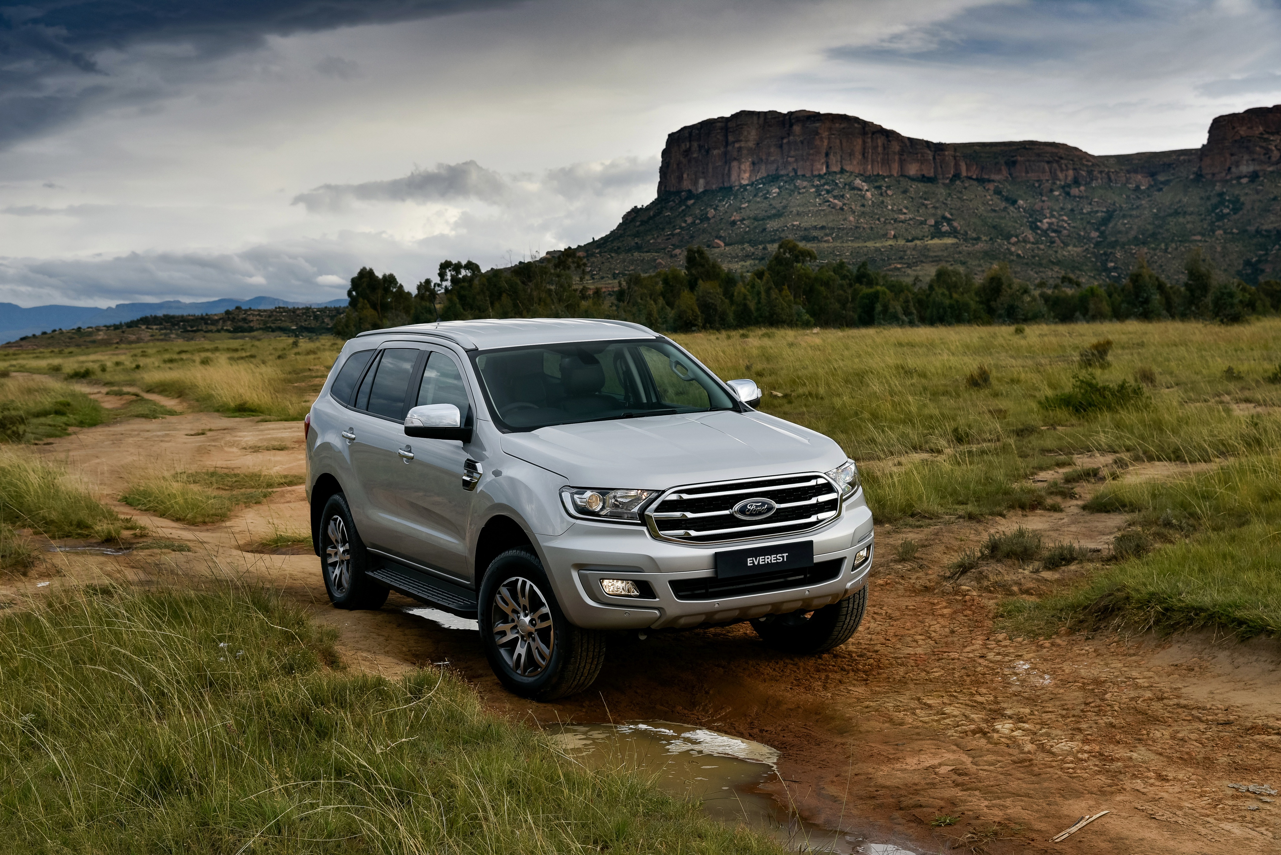 Silver Ford Everest SUV on a dirt road HD Wallpaper