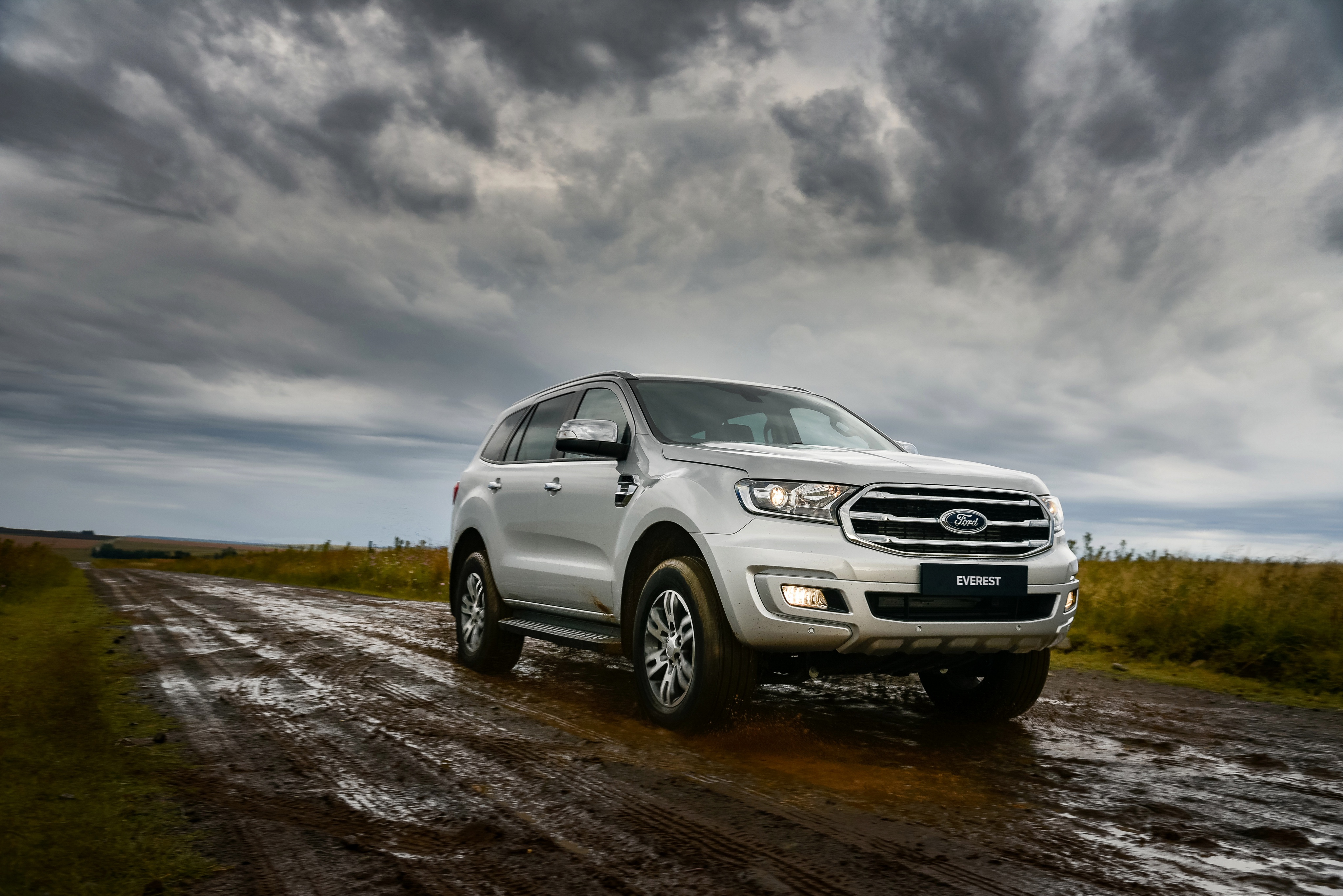 Silver Ford Everest SUV on a muddy road HD Wallpaper