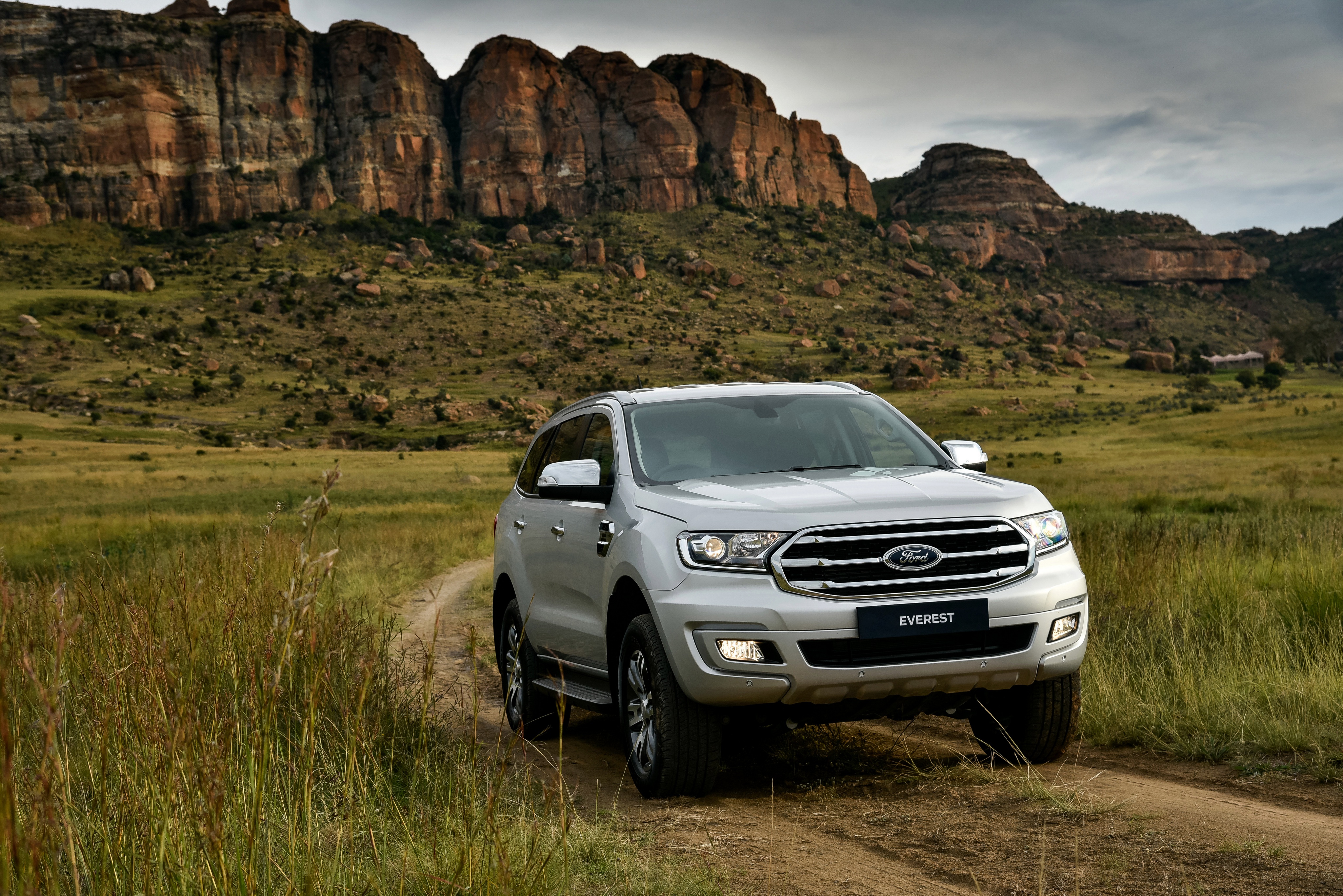 Silver Ford Everest SUV in a rocky landscape HD Wallpaper