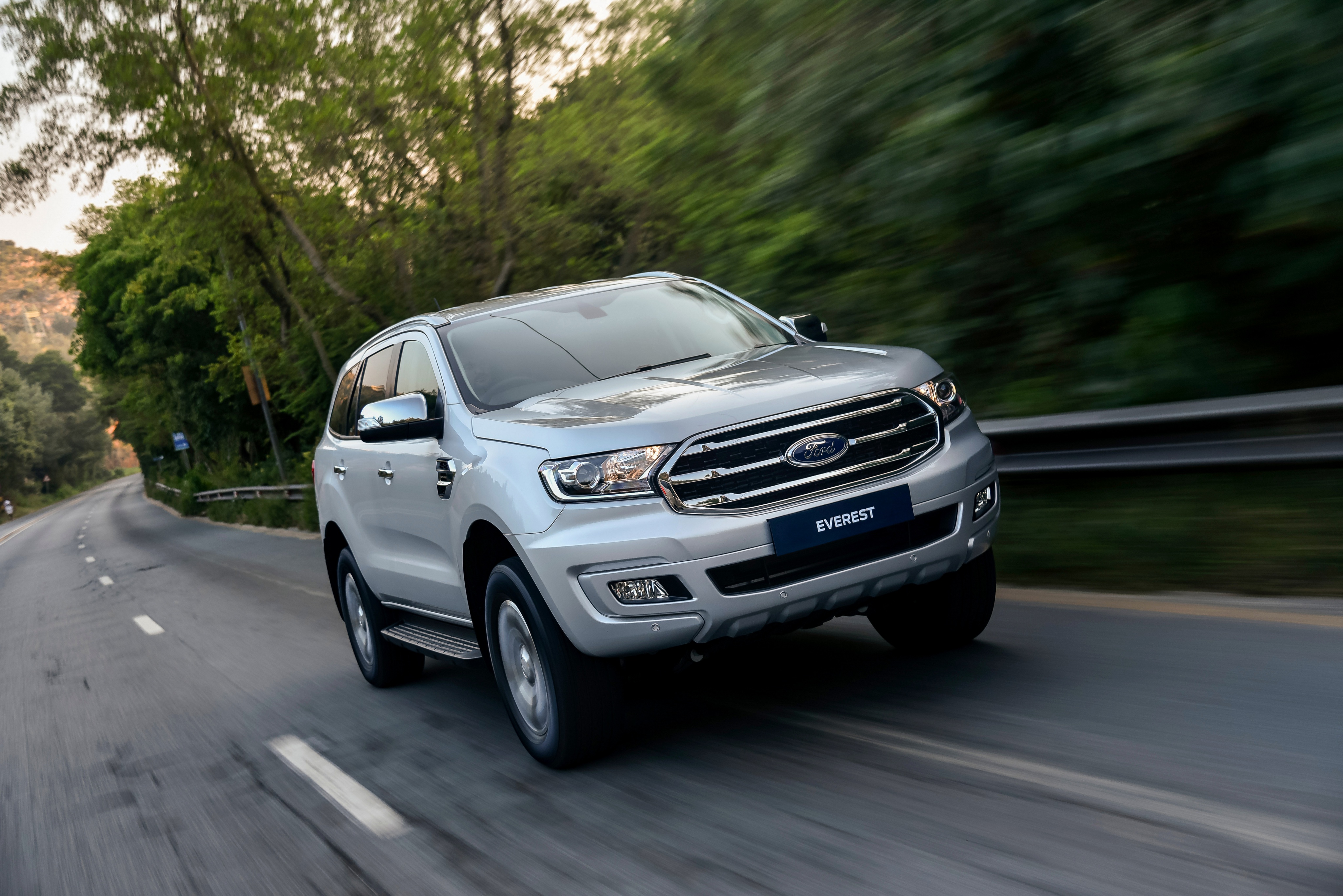Silver Ford Everest SUV driving on a road HD Wallpaper